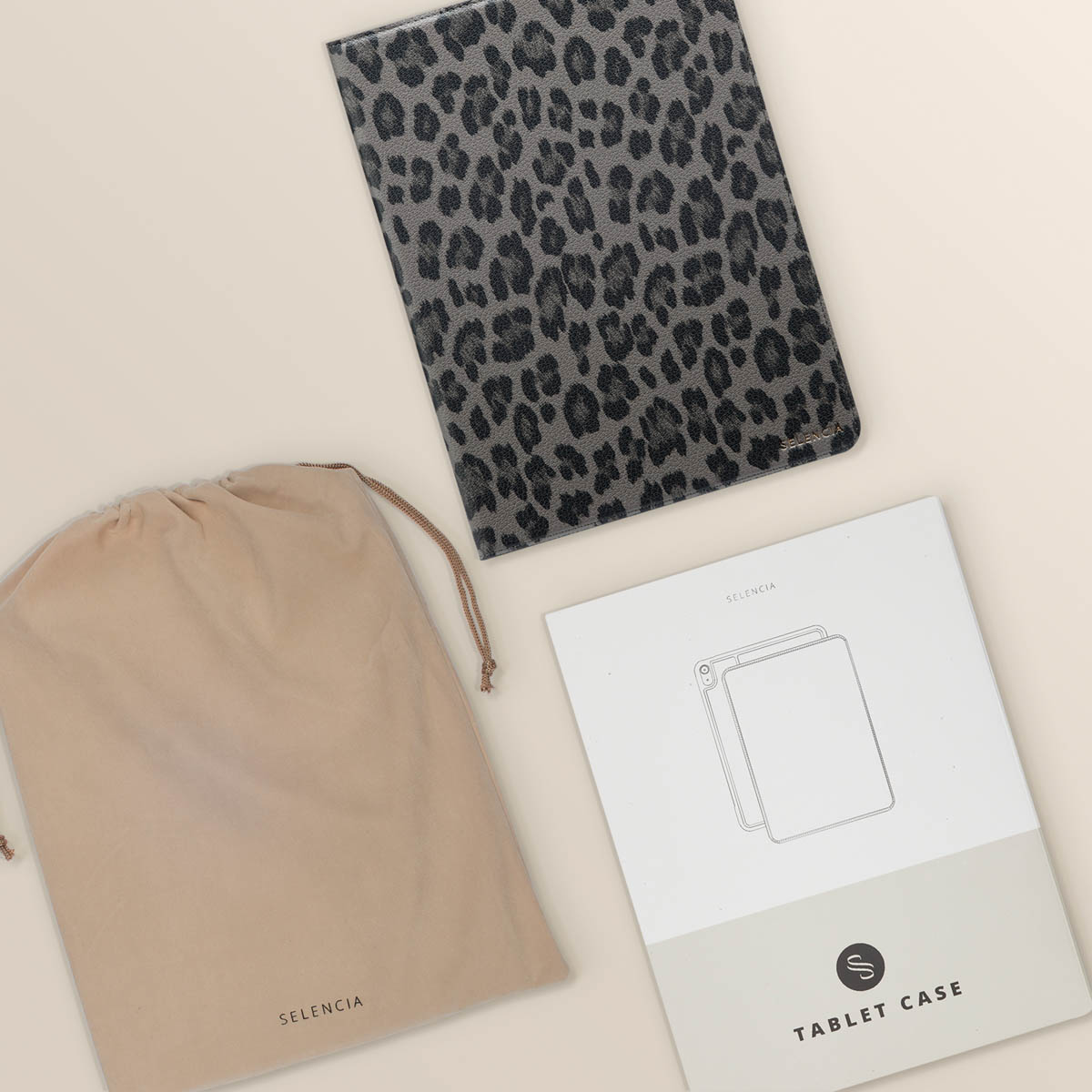 Tablet case, pouch, and a document. Case has leopard print. Pouch is beige. Document shows a tablet outline.