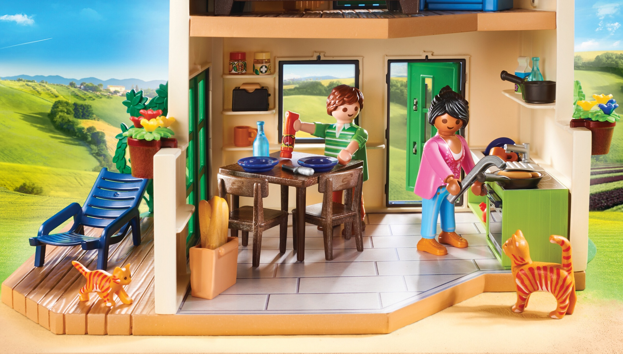 Playmobil house interior with a family cooking and eating, with cats.