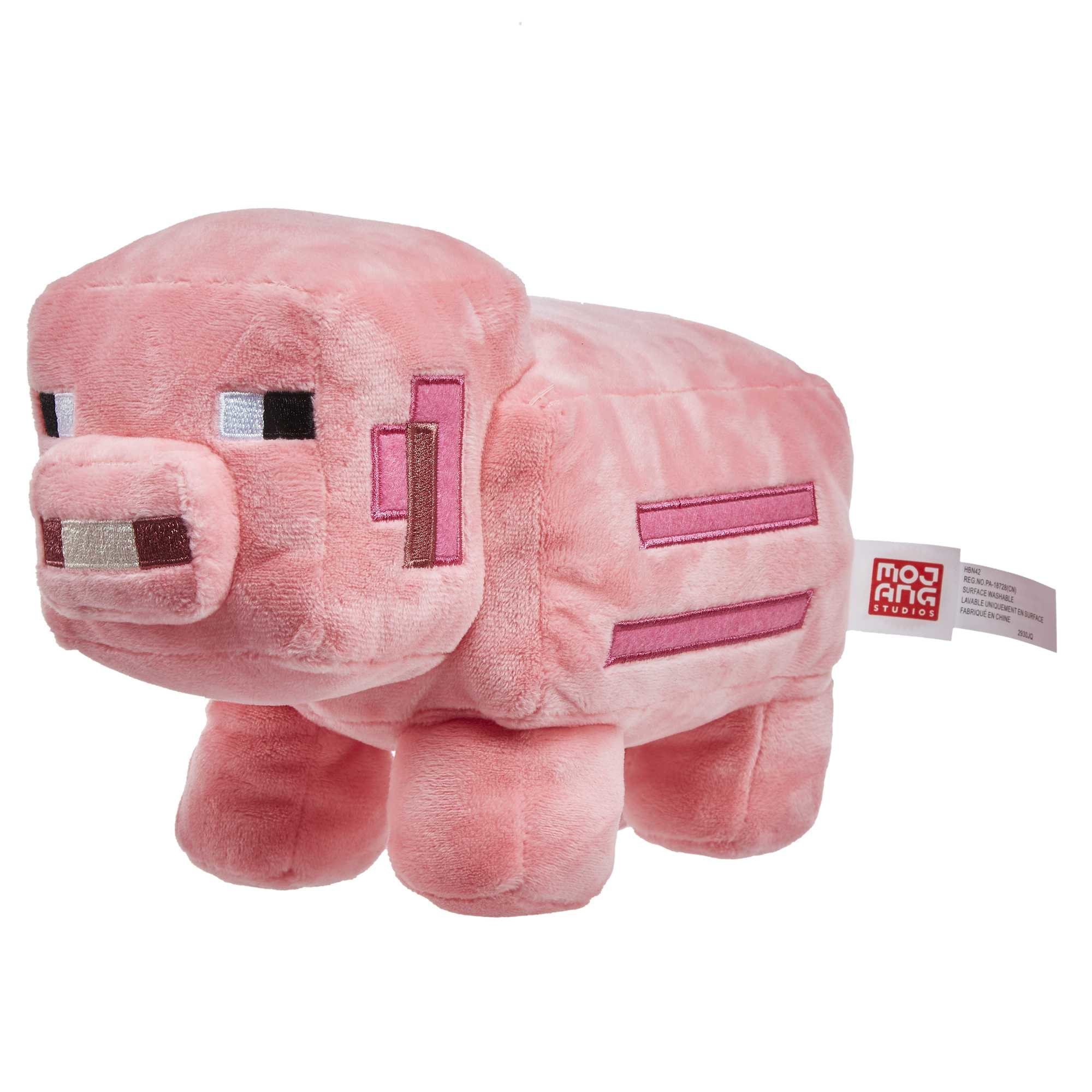 Un peluche de cerdo Minecraft rosa con detalles de su diseño Minecraft.
