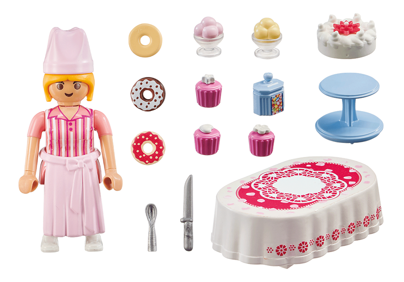 Une figurine Playmobil et divers articles de boulangerie sont présentés. Il y a une table avec un gâteau, des beignets et des cupcakes.