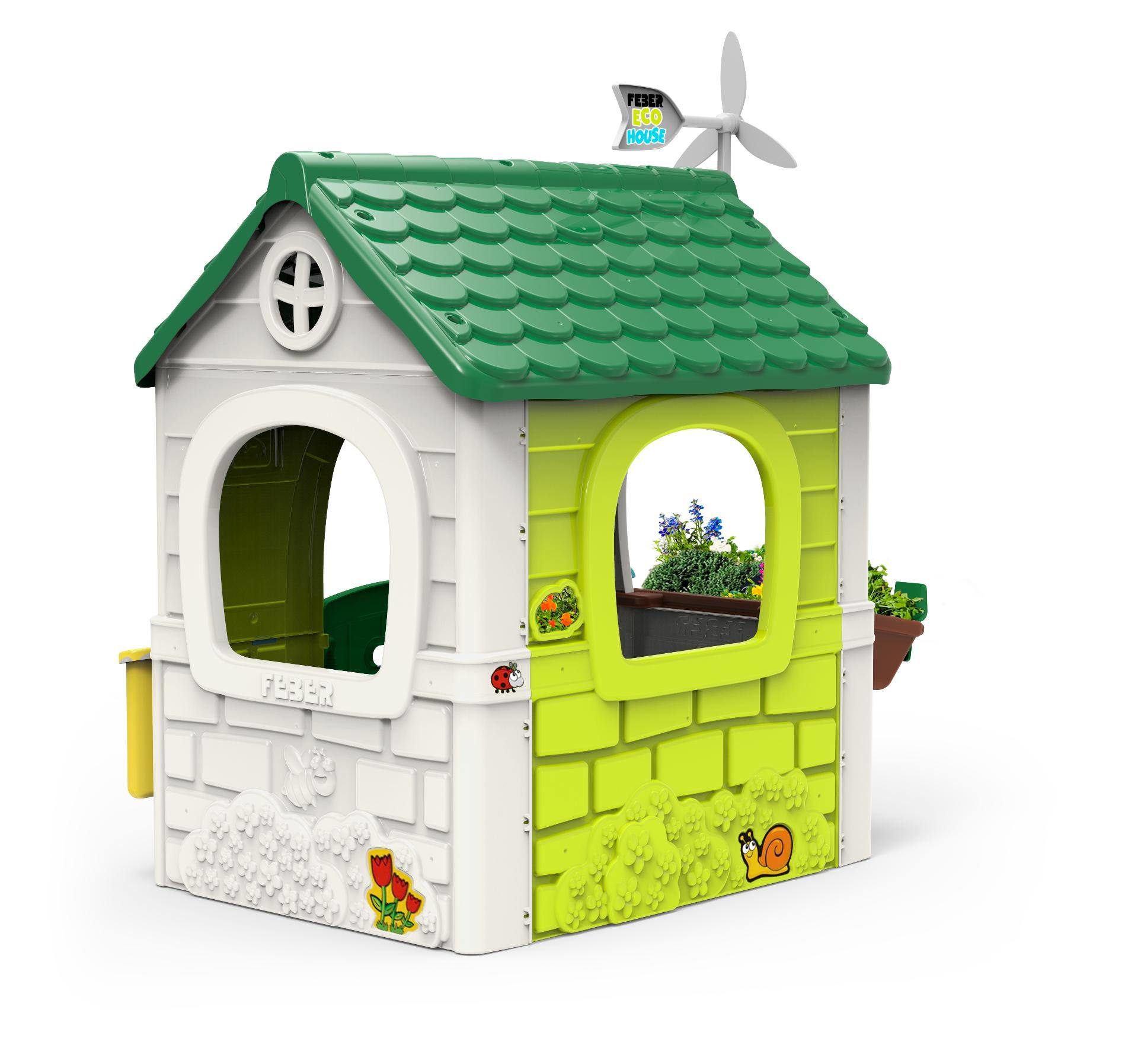 Una casita de juego de plástico colorido con techo verde y un pequeño molino de viento. Tiene ventanas y un pequeño jardín.
