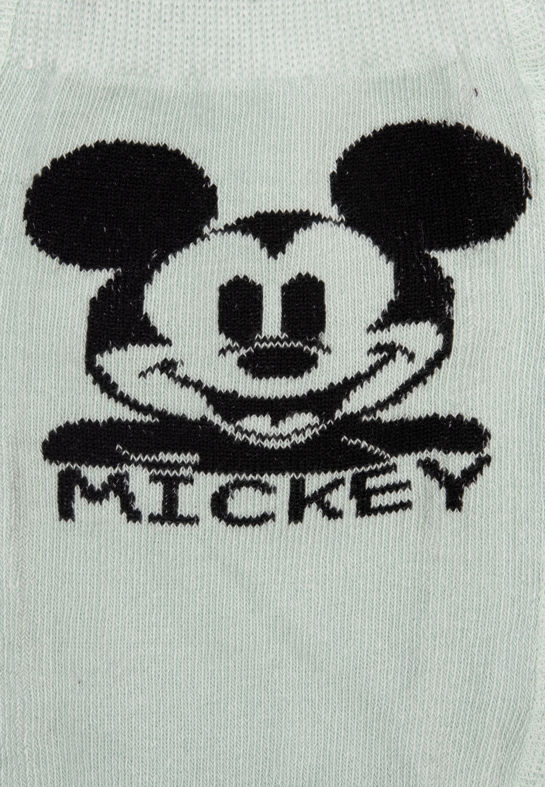 Nahaufnahme einer mintgrünen Strumpfhose. Mickey Mouses Gesicht ist sichtbar.