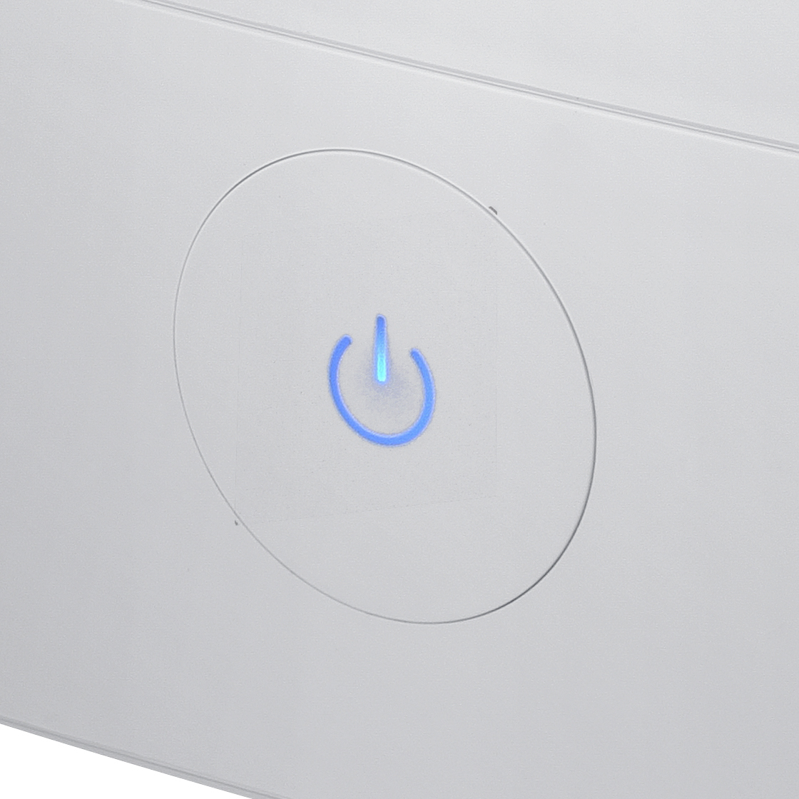 Biały panel z niebieskim przyciskiem zasilania świecącym w okręgu.