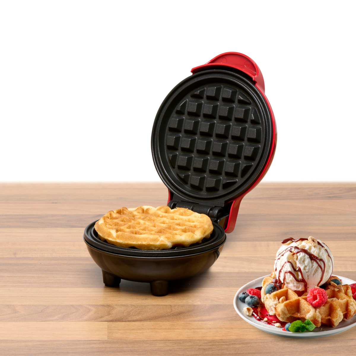 Waffle maker with a waffle inside. Waffles and ice cream are on the side. The background is wood.
