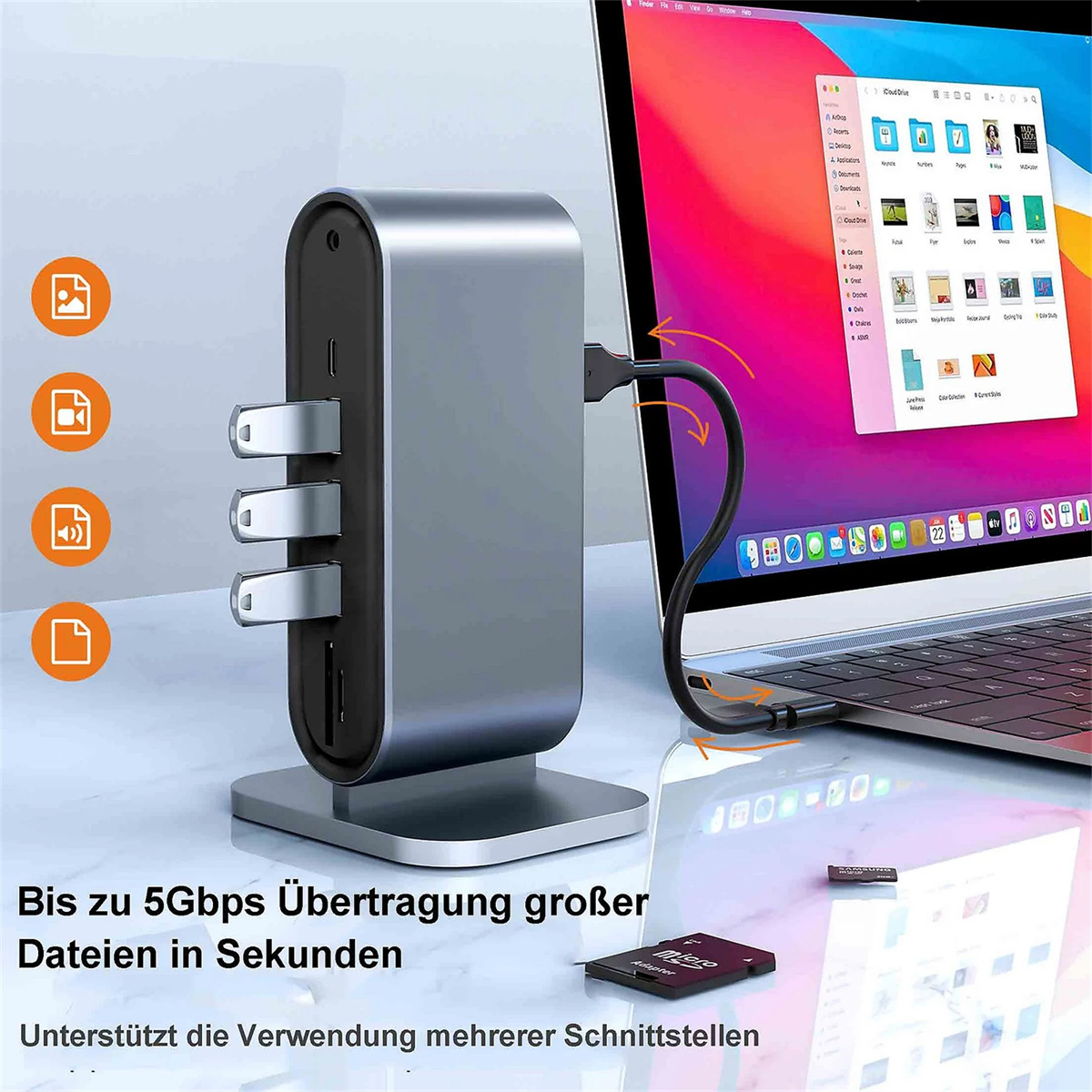Silberner Hub mit Anschlüssen, an Laptop angeschlossen. Symbole für USB, Tastatur, Maus und Drucker.