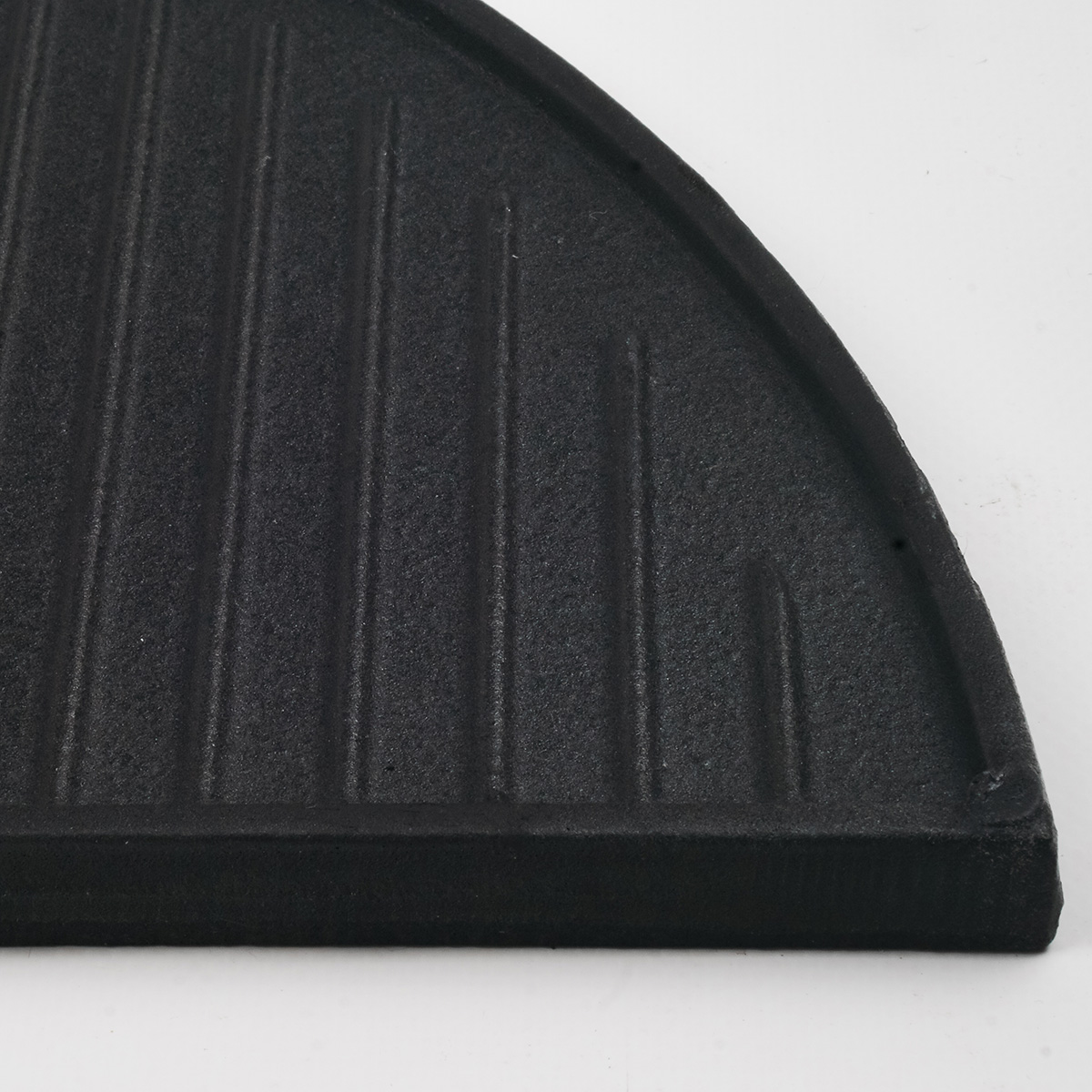 A black, semicircular grill grate with vertical lines.