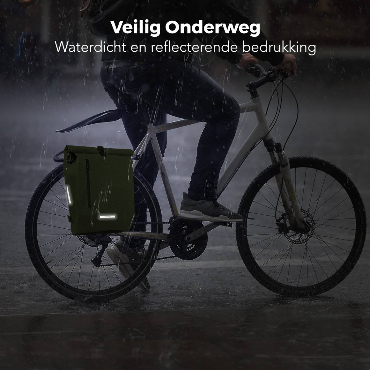 A person on a bike rides in the rain. The bike has a green pannier bag on the back.