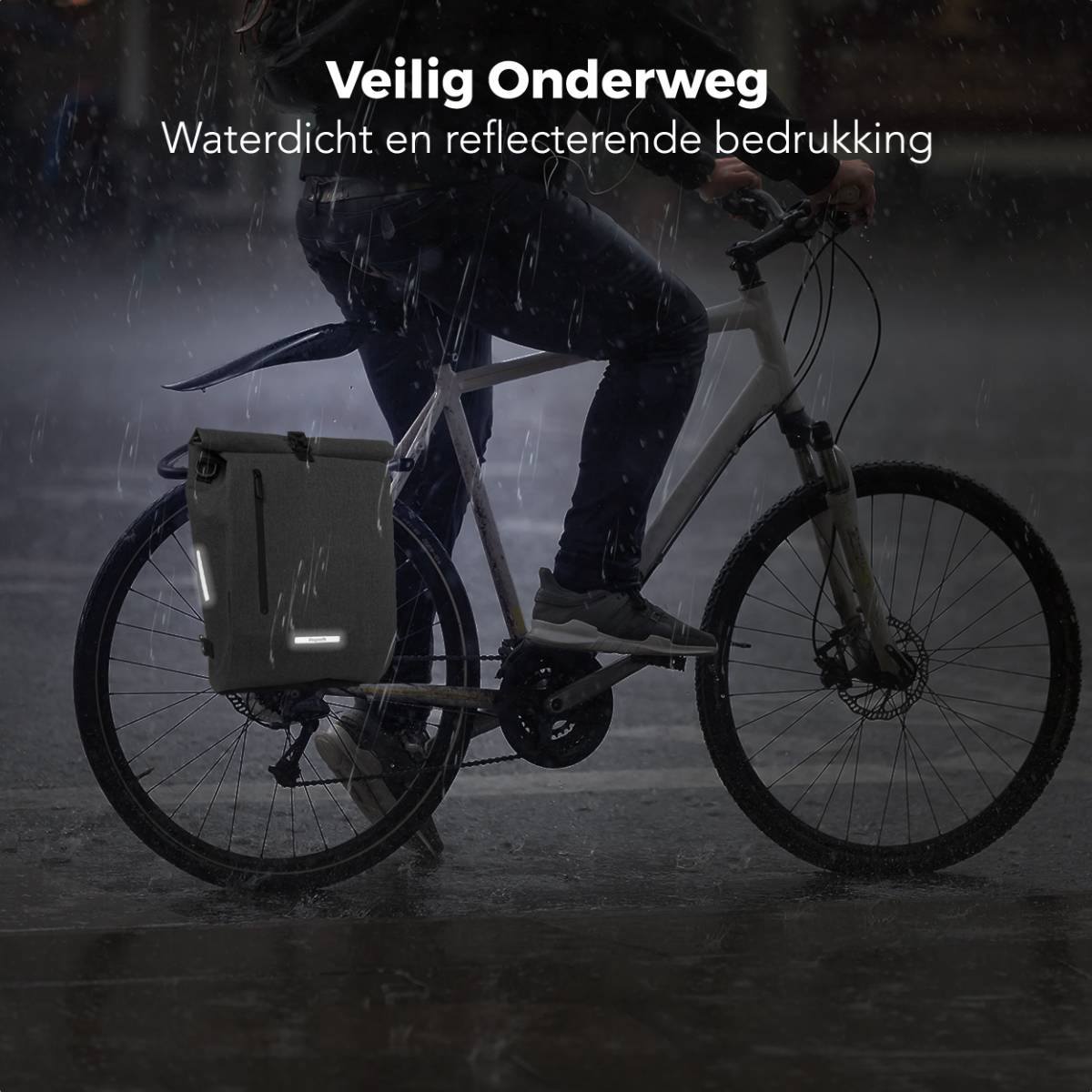 A cyclist rides a bike in the rain with a grey bag on the back. Reflective stripes are visible.