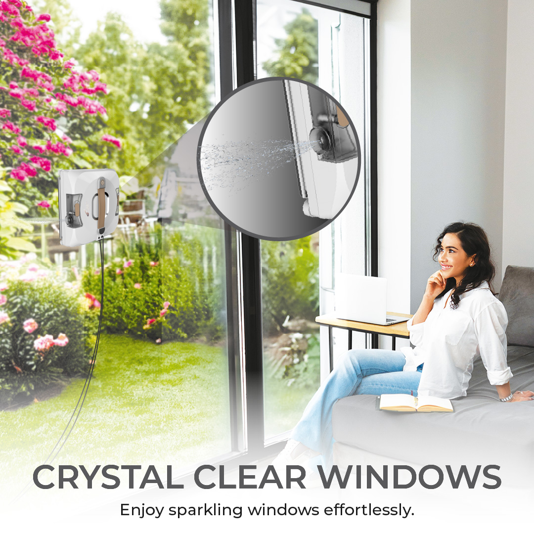 Woman sitting by a window, robot cleaner cleaning. Outside, trees.