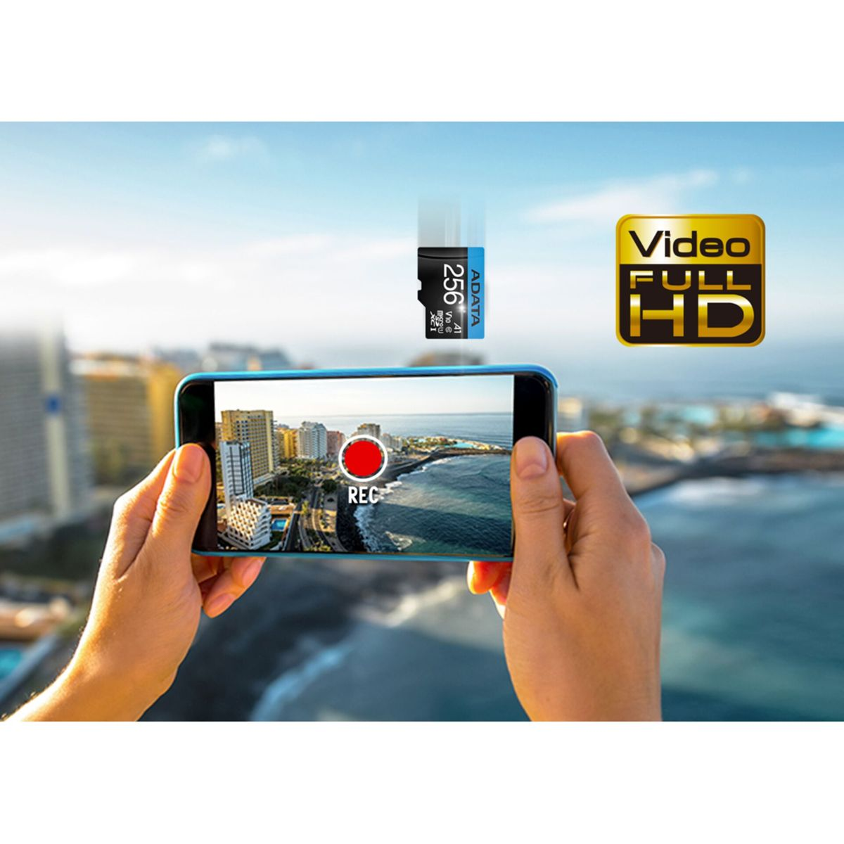 Dłonie trzymają smartfon przed krajobrazem. Tekst: Wideo Full HD, karta SD.