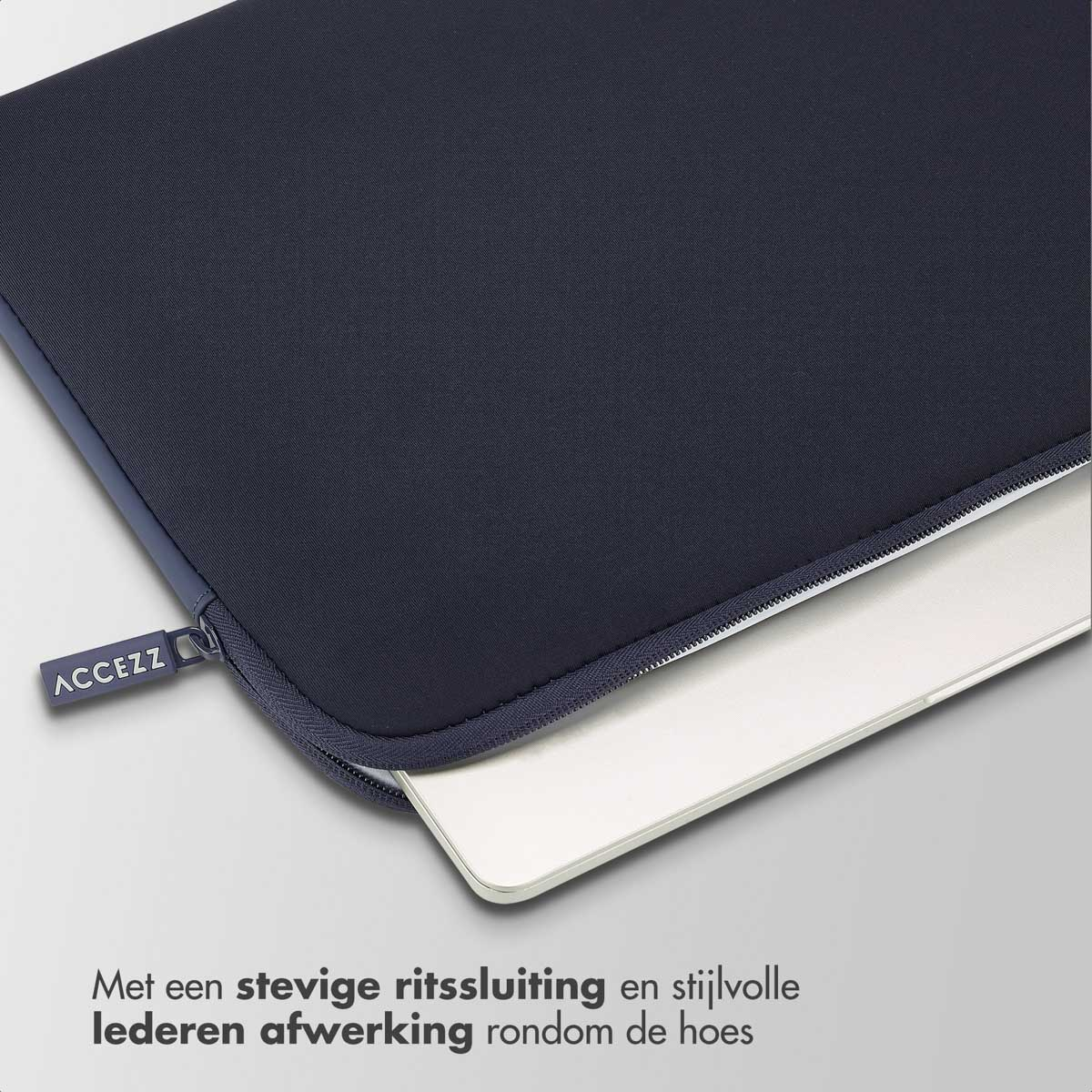 Navy blue laptop case with a zipper. A laptop is partially visible inside. Text says "ACCEZZ".
