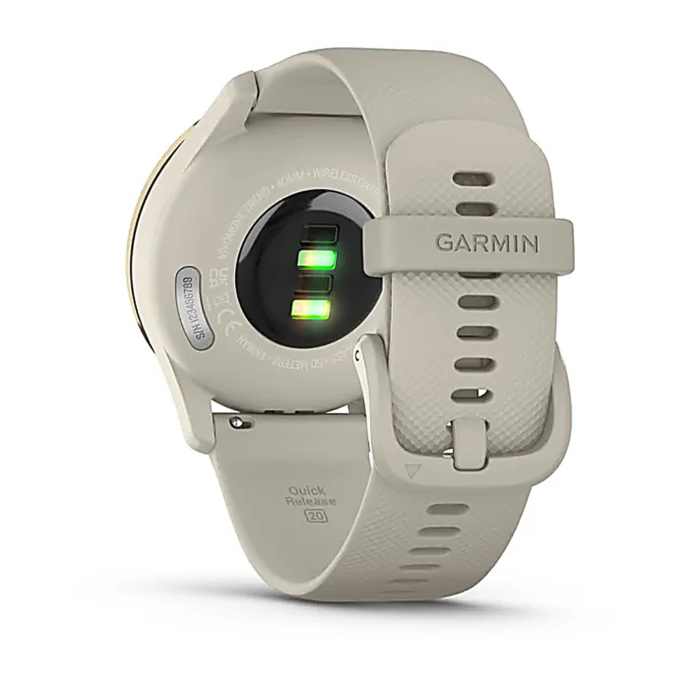 Beżowy smartwatch Garmin z czarnym ekranem i zielonym czujnikiem tętna.