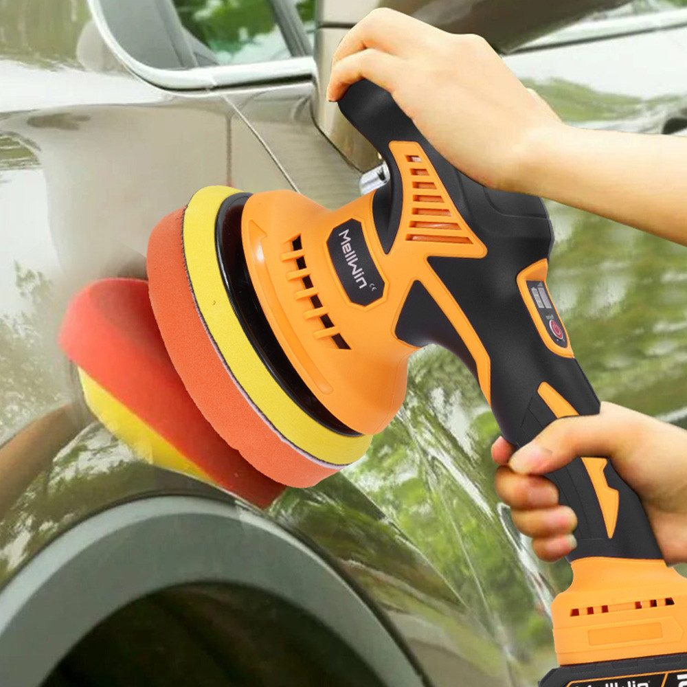 Eine Person benutzt einen elektrischen Polierer an der Karosserie eines Autos. Der Polierer ist gelb und schwarz.