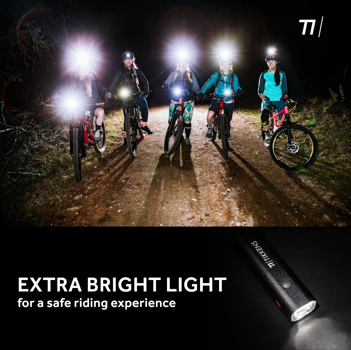 Cyclists with bright headlamps ride mountain bikes on a path at night.