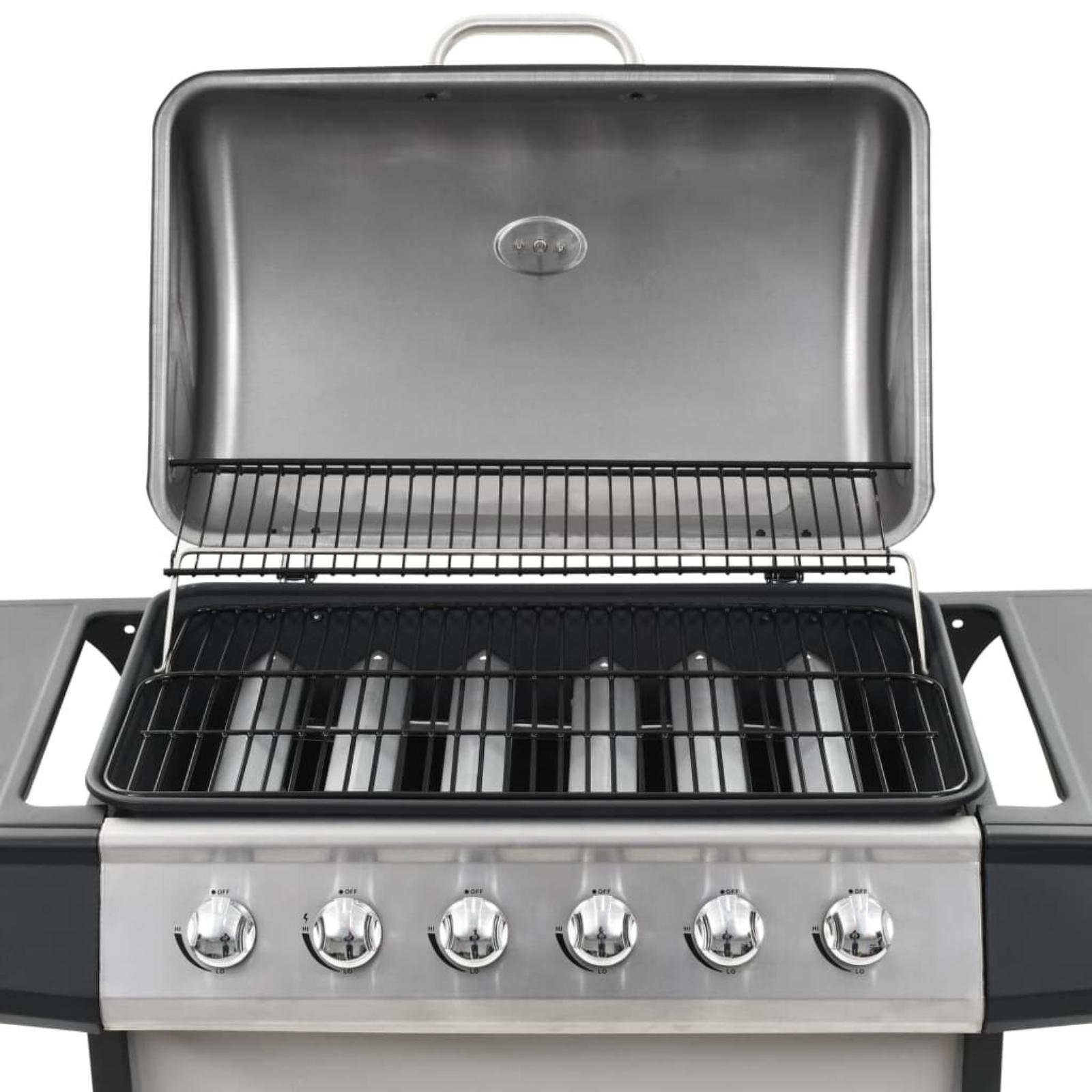 Grill-Innenraum mit offenem Deckel. Roste und Brenner sichtbar. Bedienknöpfe vorne.