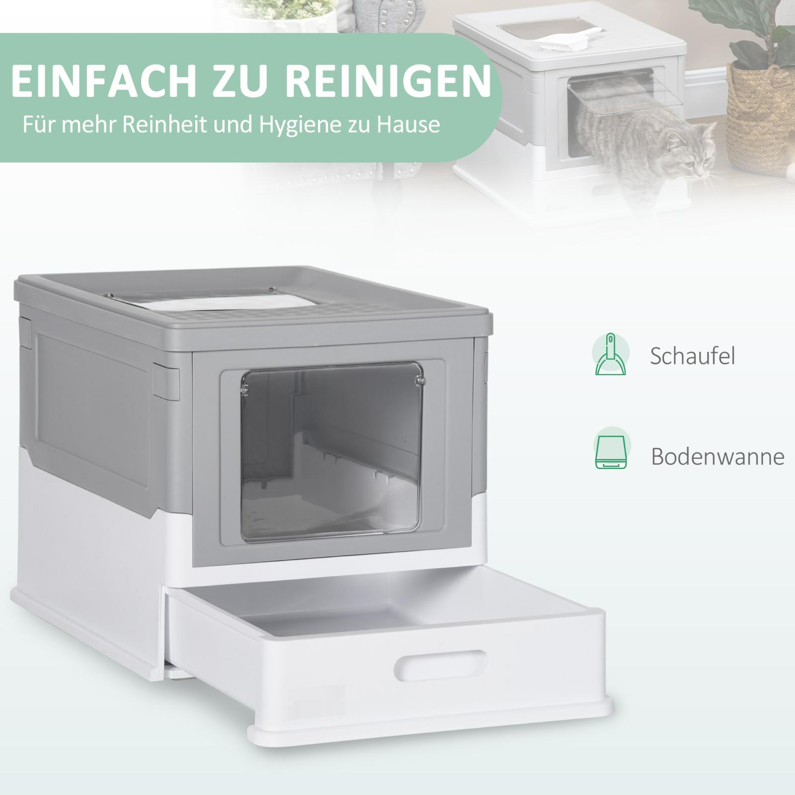 Eine offene grau-weiße Katzentoilette mit Katze sowie eine Schaufel und eine Wanne werden gezeigt.