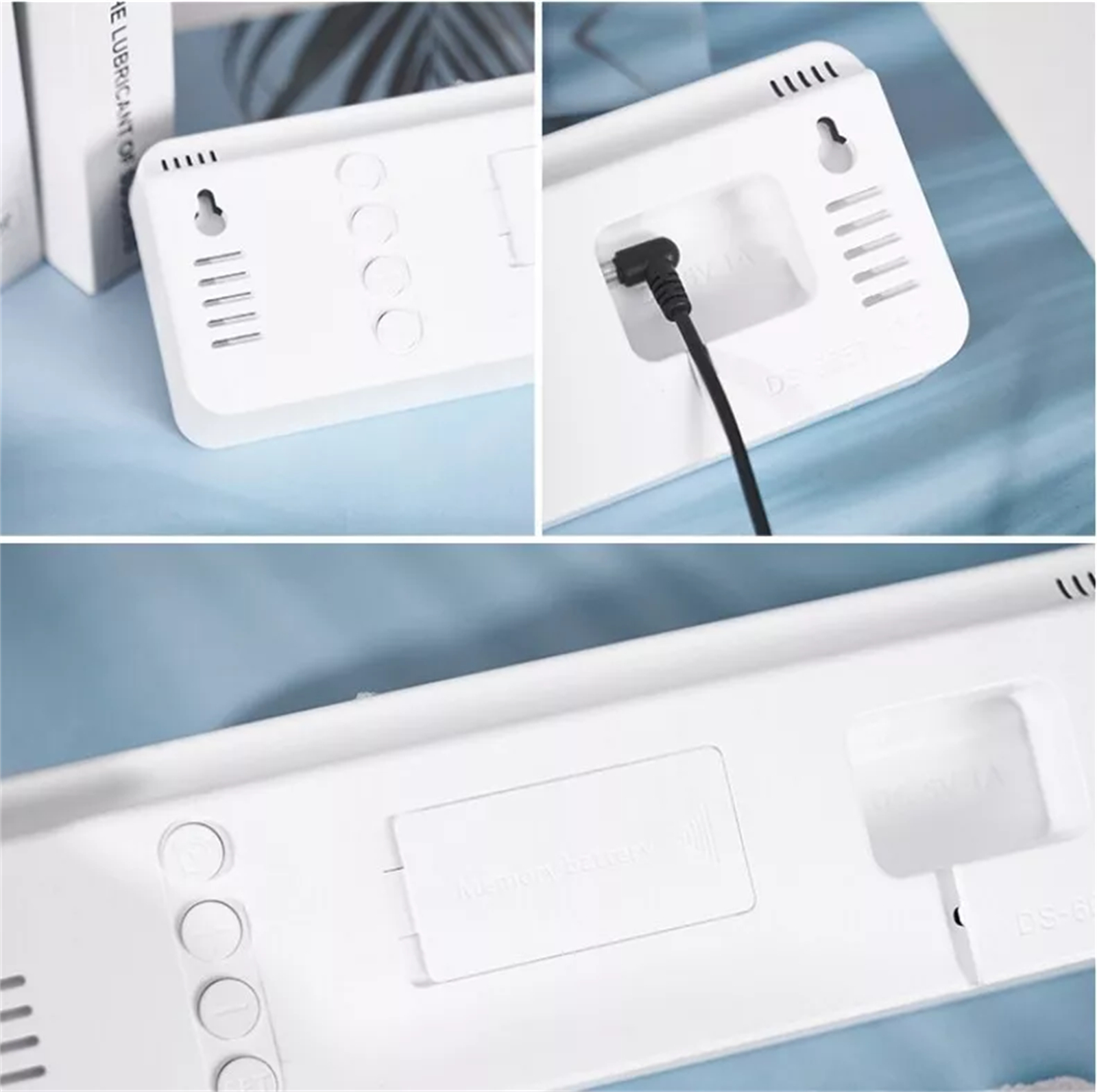 Rückseite einer weißen Digitaluhr mit Netzkabel und Befestigungslöchern, auf blauer Oberfläche.
