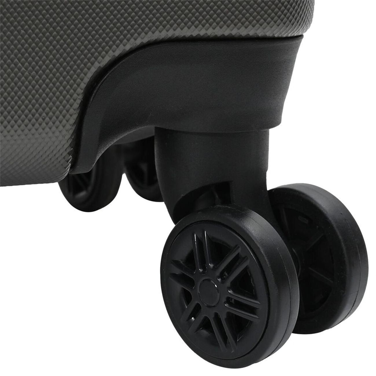 Nahaufnahme eines grauen Koffer-Rades. Schwarze Räder mit sternförmigem Design sind sichtbar.