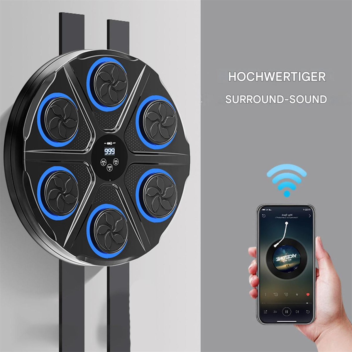 Eine schwarze Maschine mit 6 fächerförmigen Öffnungen, ein Telefon mit einer Musik-App, an einer Wand.