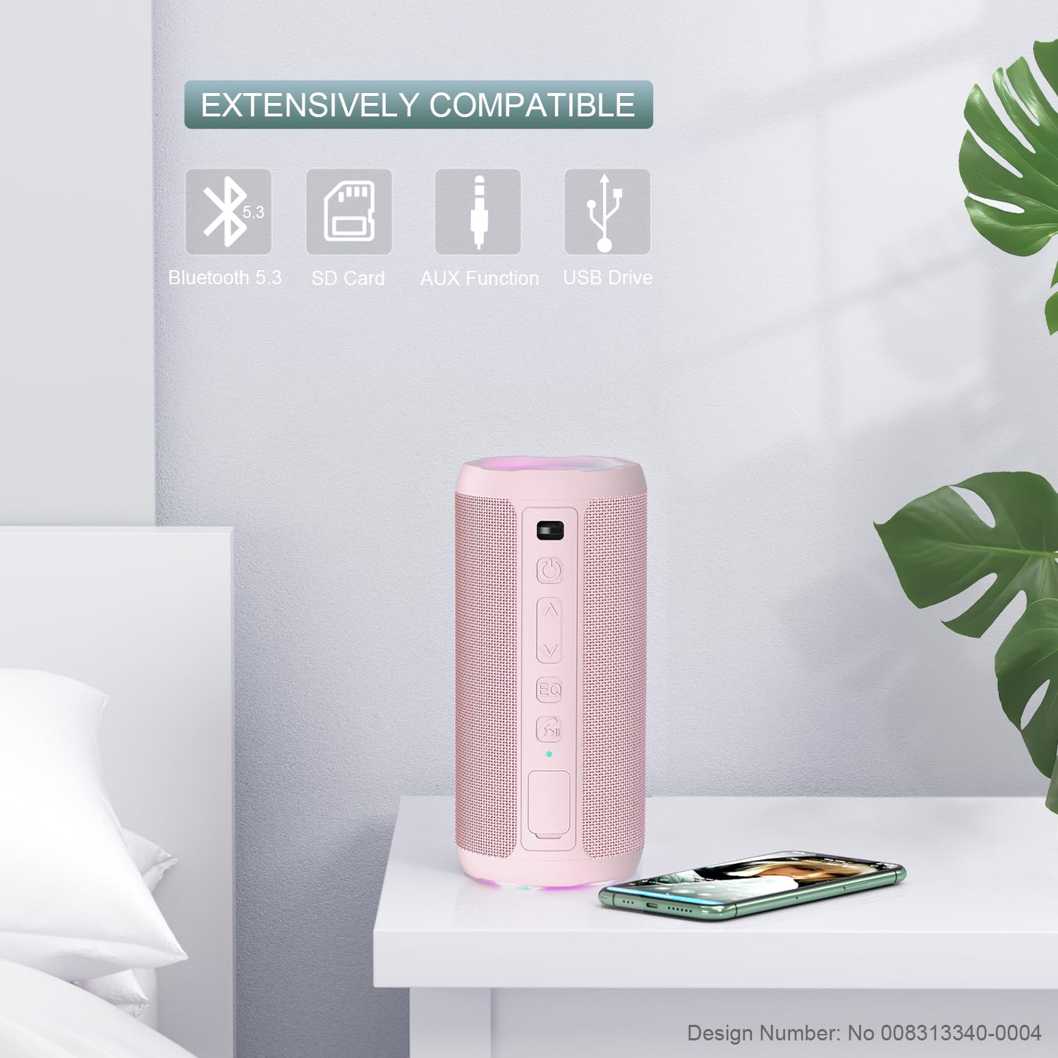 Ein rosa Lautsprecher auf einem Tisch, mit Symbolen für Bluetooth, SD-Karte, AUX und USB. Ein Telefon steht daneben.
