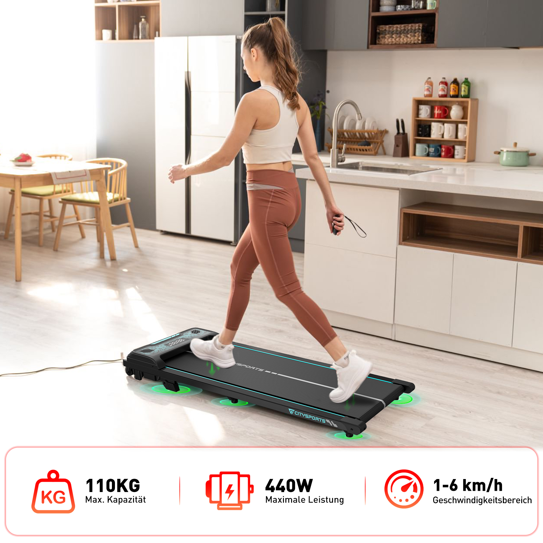 Eine Frau geht in einer Küche auf einem schwarzen Laufband. Produktdetails: 110 kg max. Kapazität, 440 W Leistung, 1-6 km/h Geschwindigkeit.