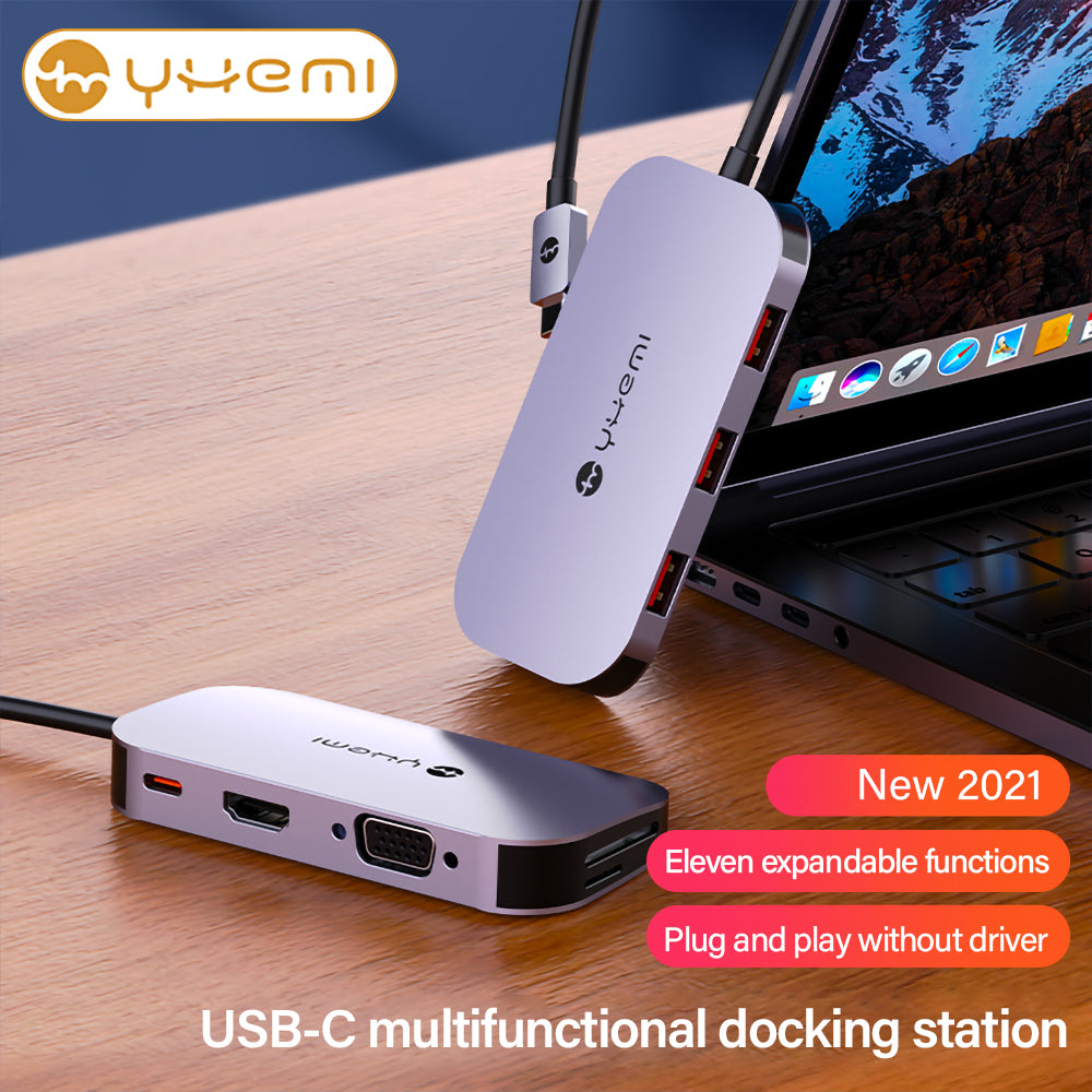 Silberne USB-C-Dockingstation mit mehreren Anschlüssen, an einen Laptop angeschlossen. Text: 'Neu 2021', '11 Funktionen', 'Plug & Play'.
