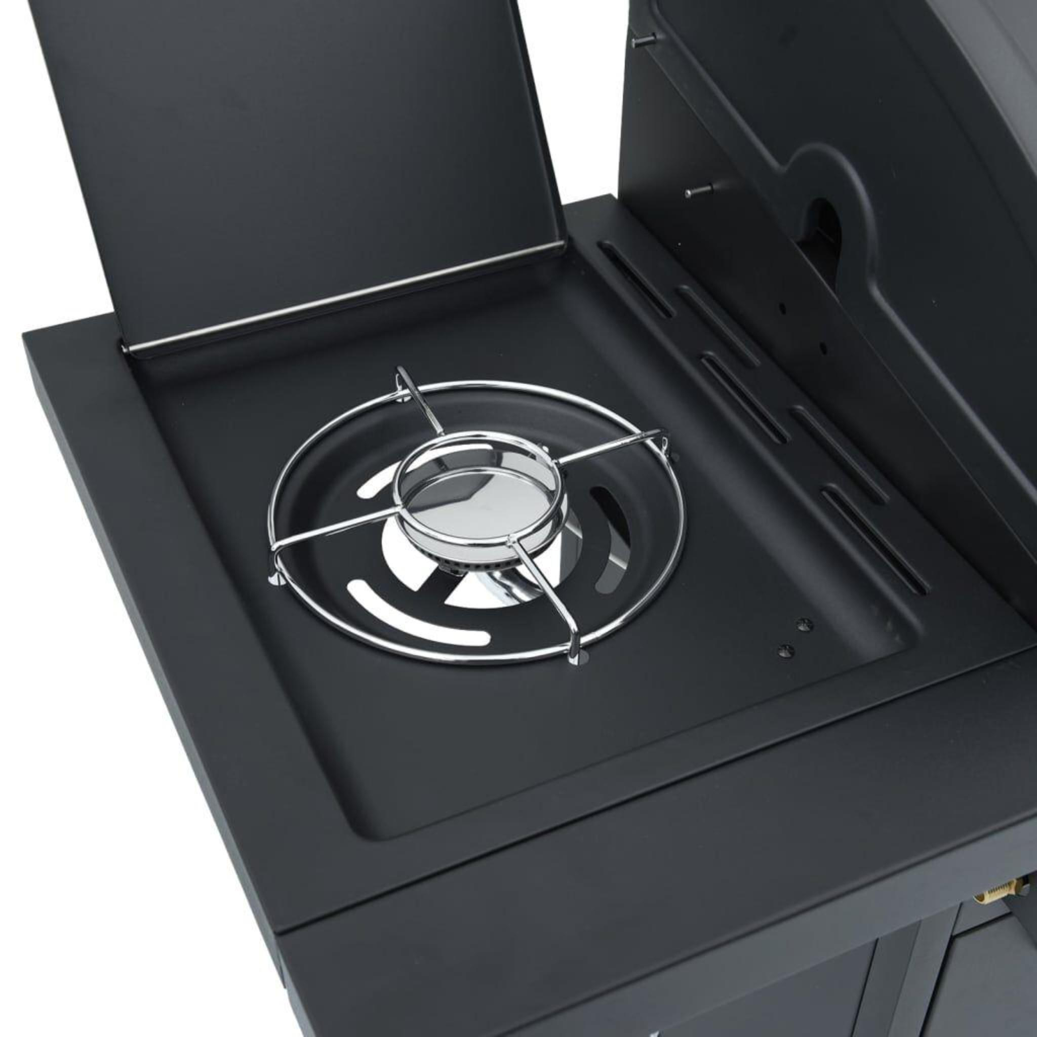 Nahaufnahme des Inneren eines schwarzen Gasgrills mit Brenner und Metallgrill.