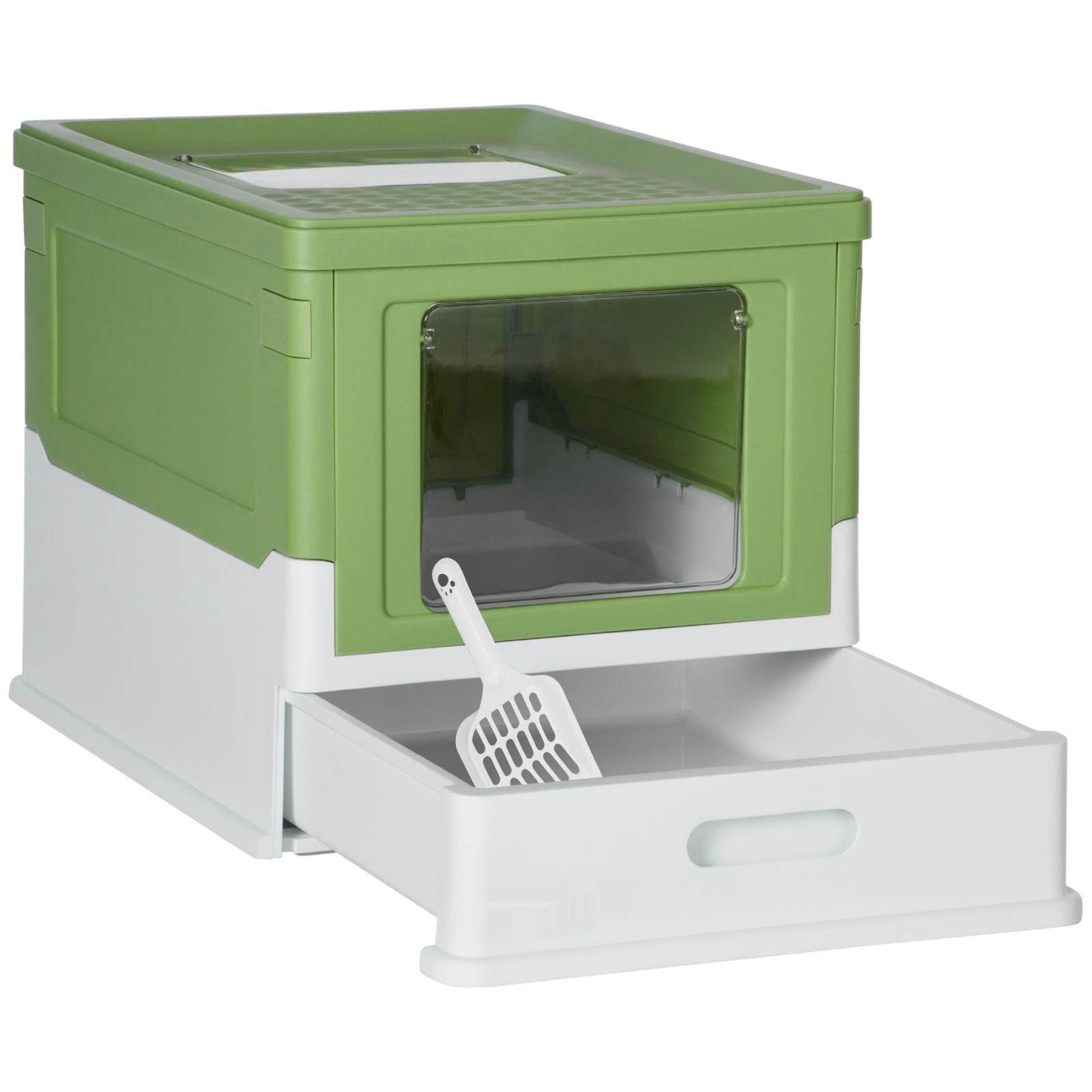 Eine grüne und weiße Katzentoilette mit Schublade für Abfall. Enthält eine Schaufel.