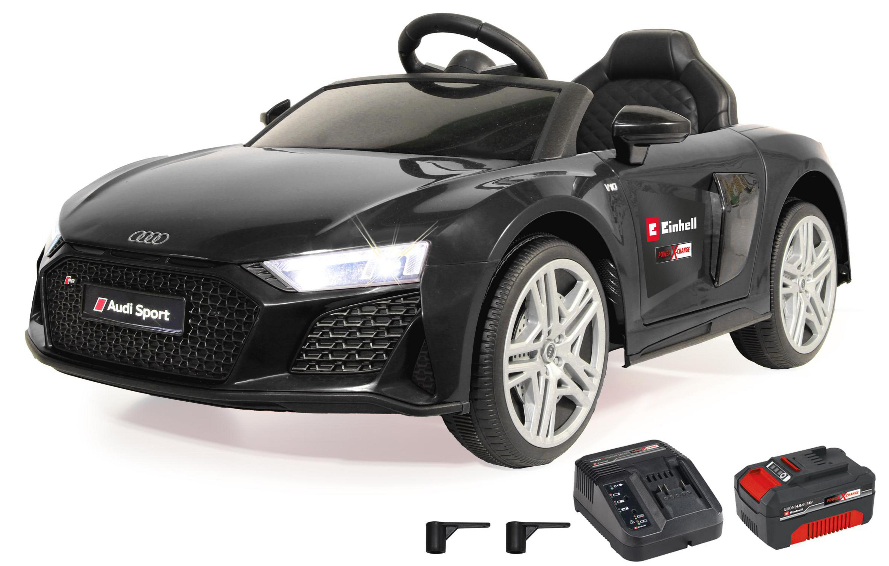 Schwarzes Audi R8 Spielzeugauto mit eingeschaltetem Licht, Ladegerät und Akku vorne.