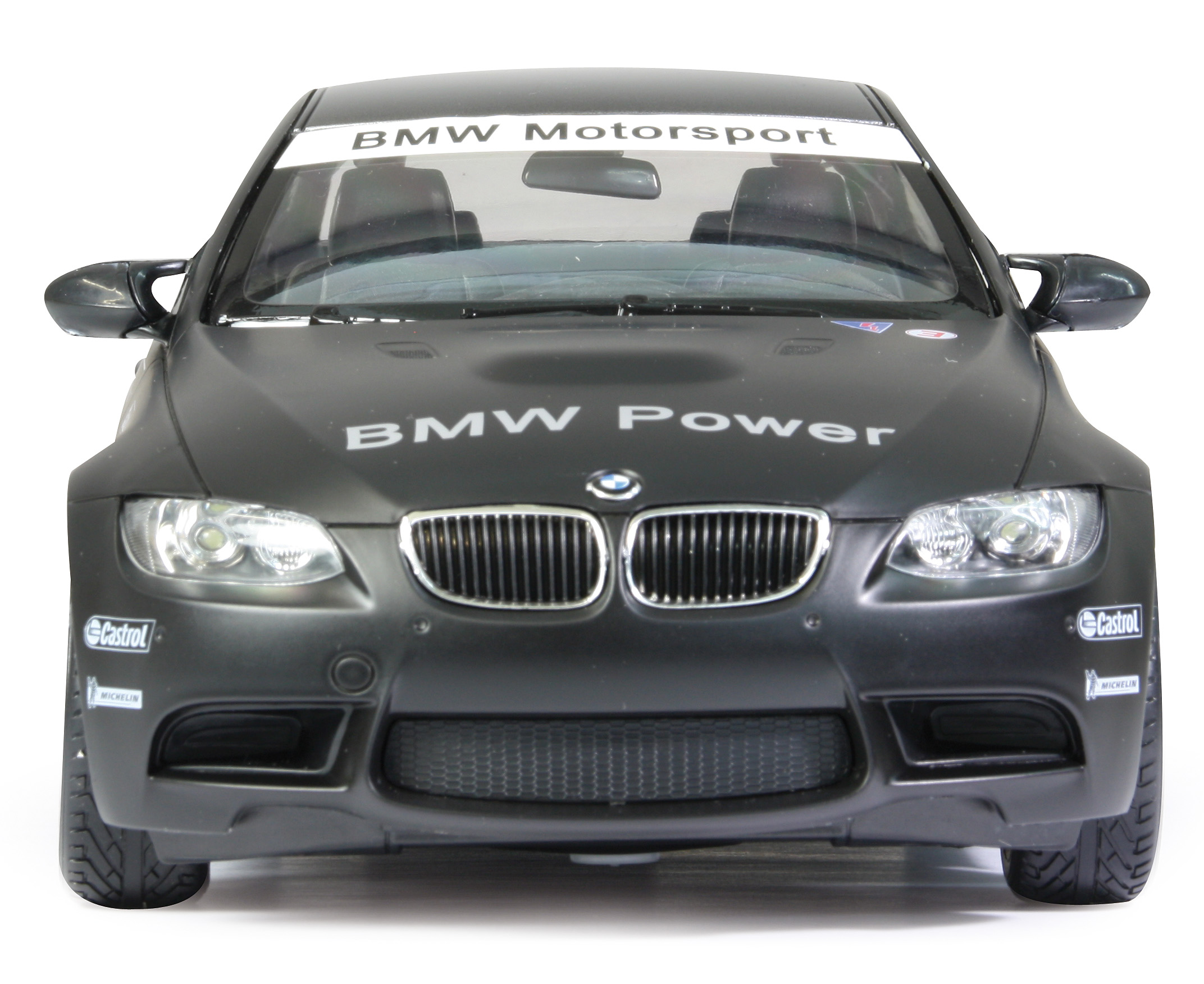 Czarny samochodzik BMW M3 zabawka, widok z przodu, z włączonymi reflektorami, marką BMW Power i logo.