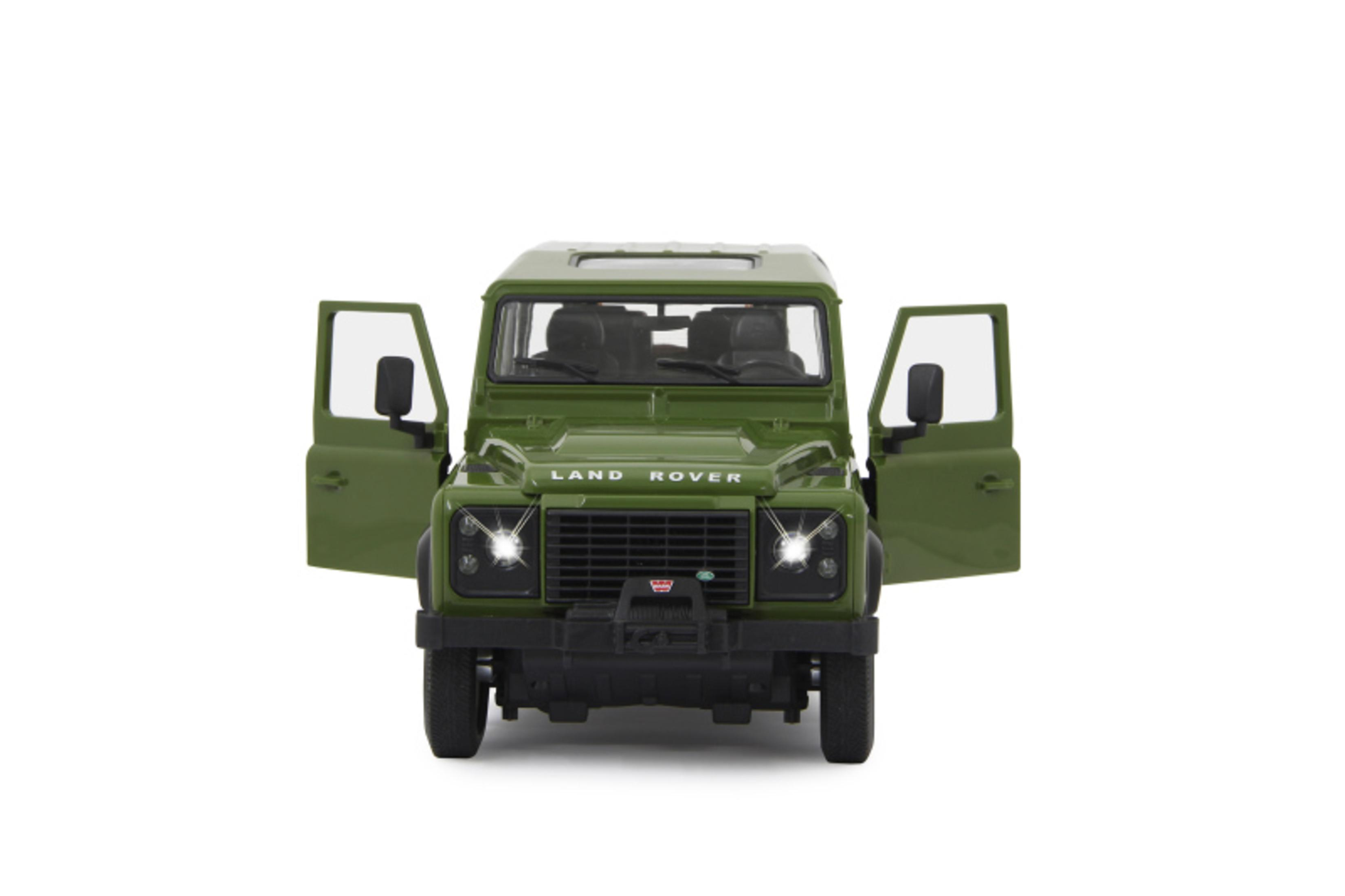Grünes Land Rover Spielzeugauto mit offenen Türen, Innenraum zeigend, auf weißem Hintergrund.