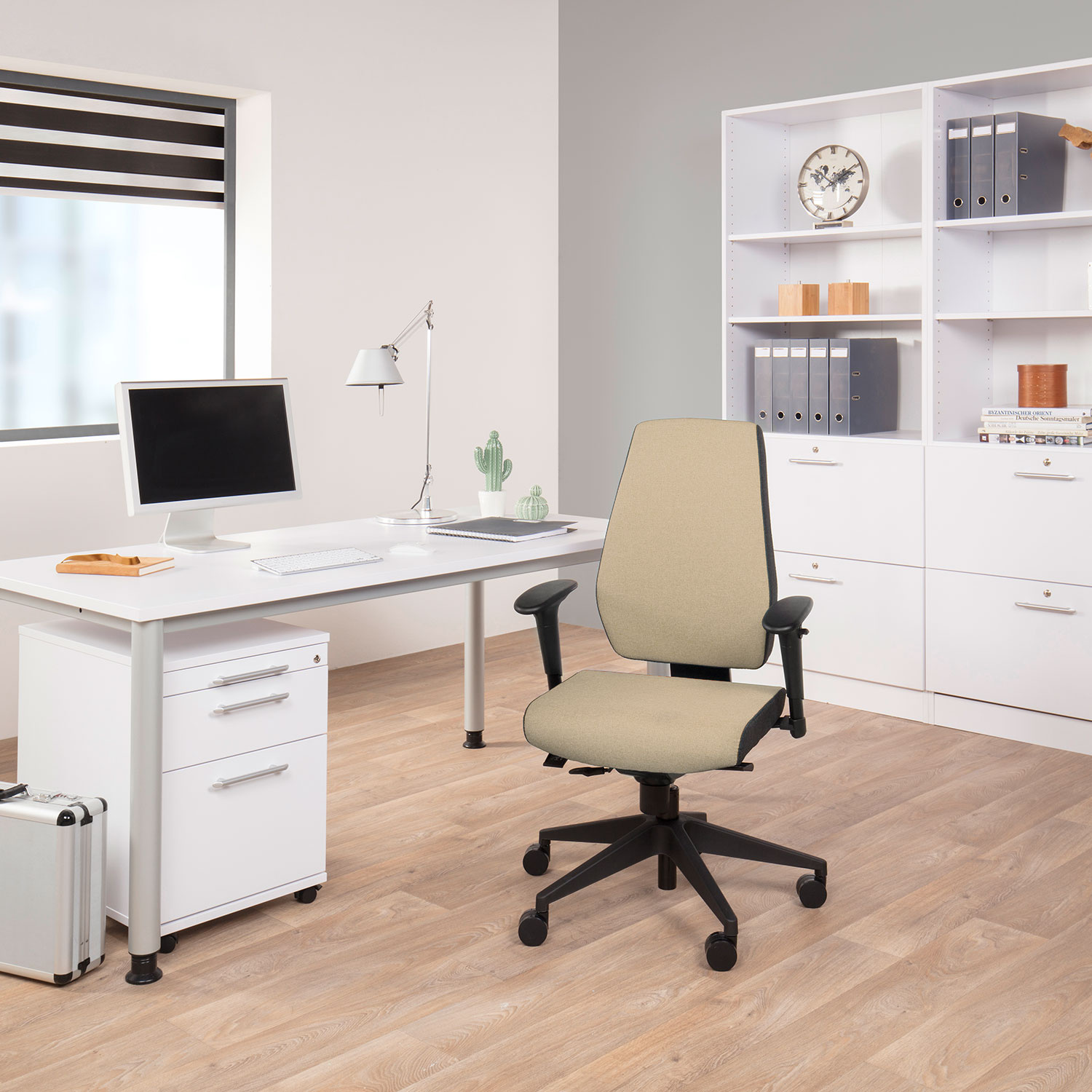 Büro-Innenraum mit Schreibtisch, Stuhl und Stauraum. Ein Fenster und ein Laptop sind ebenfalls sichtbar.