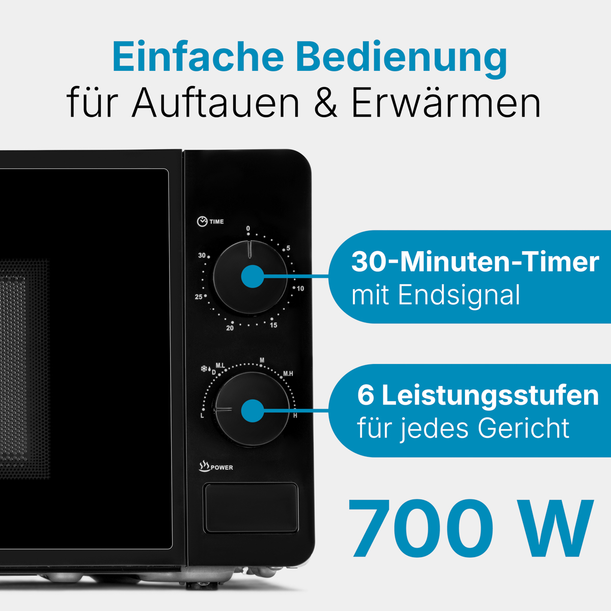 Zbliżenie czarnej kuchenki mikrofalowej z pokrętłami i tekstem '700 W'.