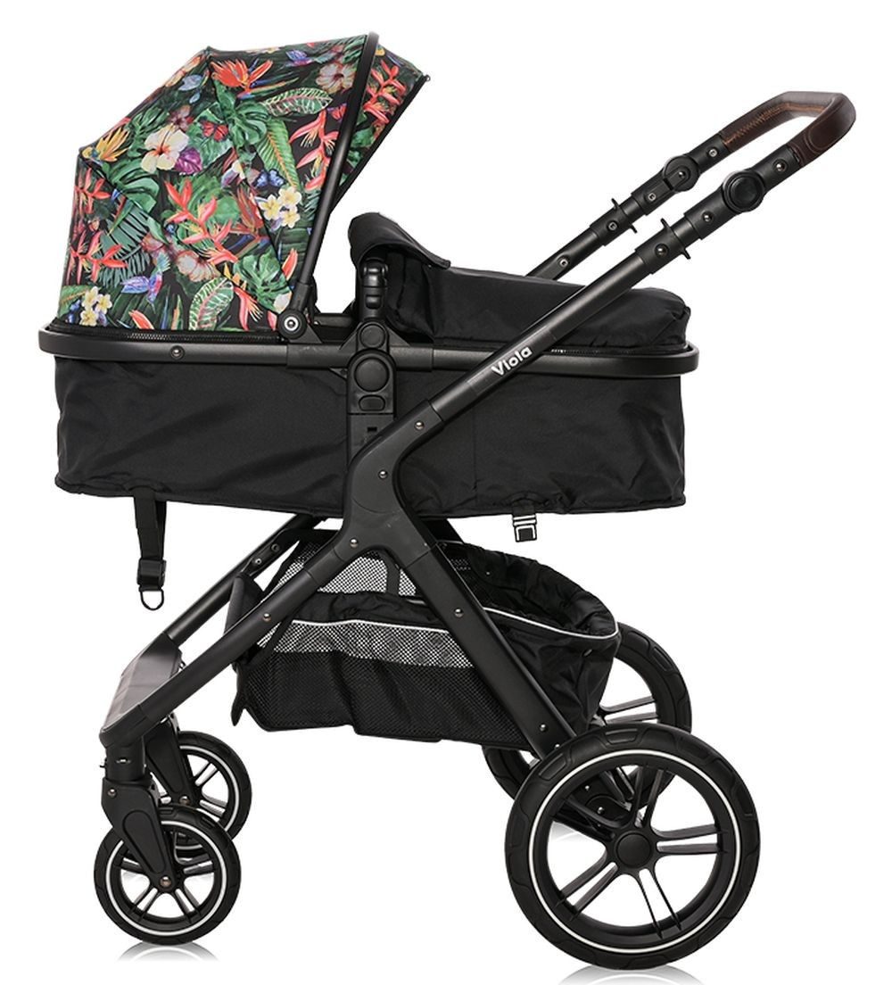 Schwarzer Kinderwagen mit floralem Verdeck. Enthält einen Korb und vier Räder. Weißer Hintergrund.