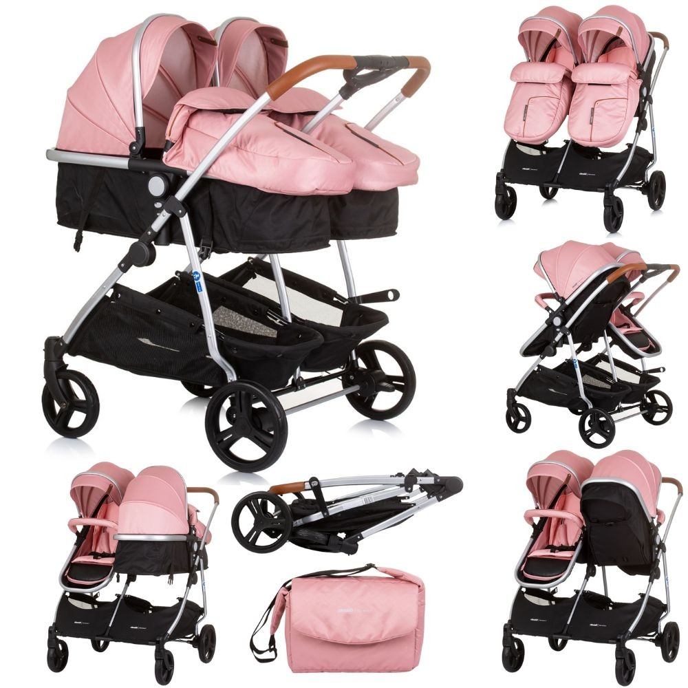 Rosa Doppelkinderwagen-Set mit zwei Sitzen. Der Kinderwagen hat schwarze Körbe und ein silbernes Gestell.