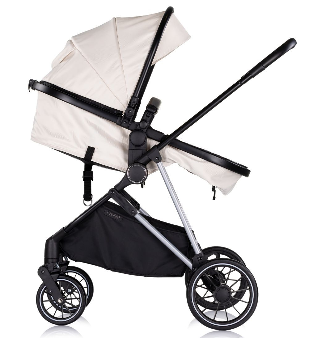 Weißer Kinderwagen mit schwarzem Rahmen. Seitenansicht.