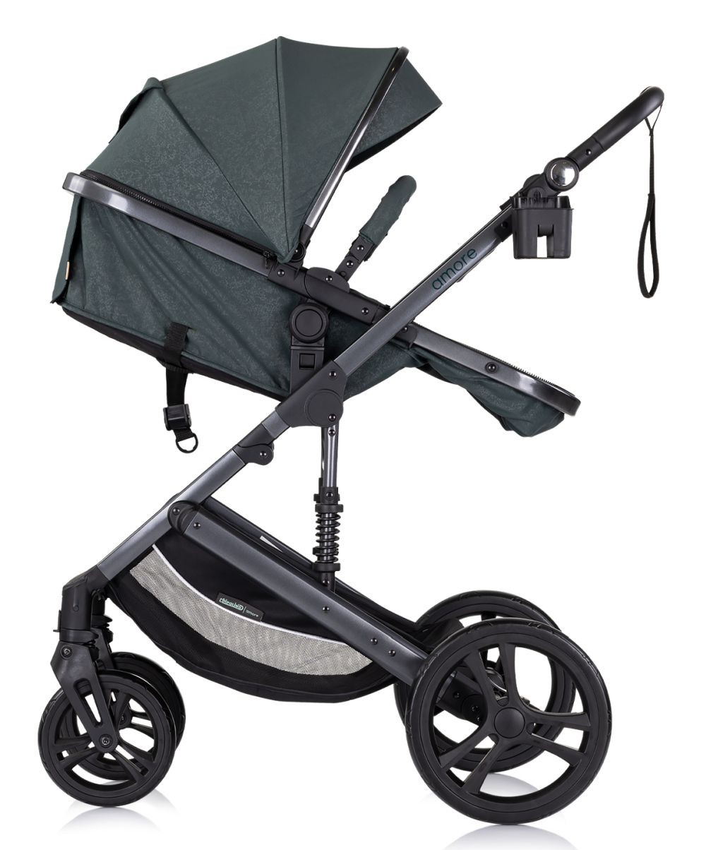 Ein dunkelgrüner Kinderwagen, Seitenansicht, schwarzer Rahmen, vier Räder, Sonnenblende hoch. Weißer Hintergrund.