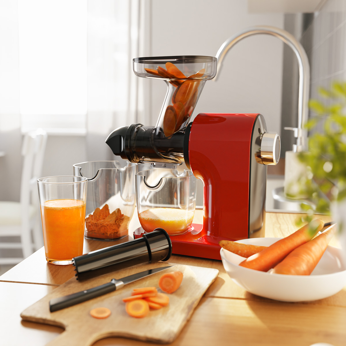 Red juicer with carrots and juice. Carrots in juicer and bowl. Kitchen setting.