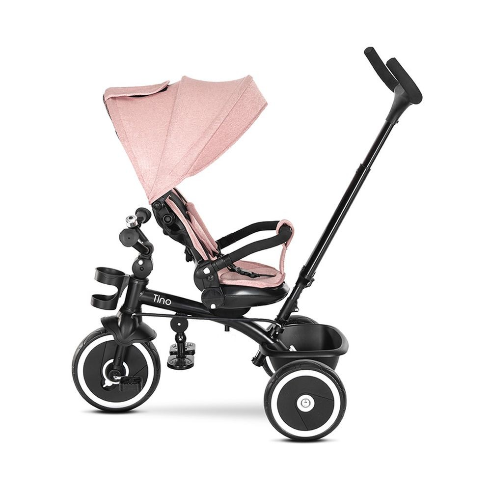 Ein rosa und schwarzes Tino-Dreirad mit Sonnenschutz. Es hat drei Räder und einen Korb.
