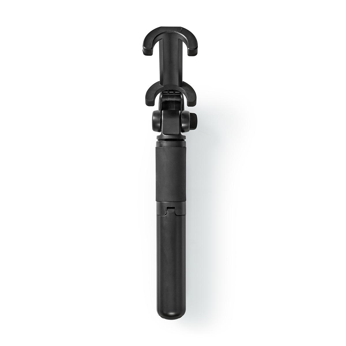 Ein schwarzer Selfie-Stick, ausgefahren, mit einer Telefonhalterung oben. Er liegt auf einer weißen Oberfläche.