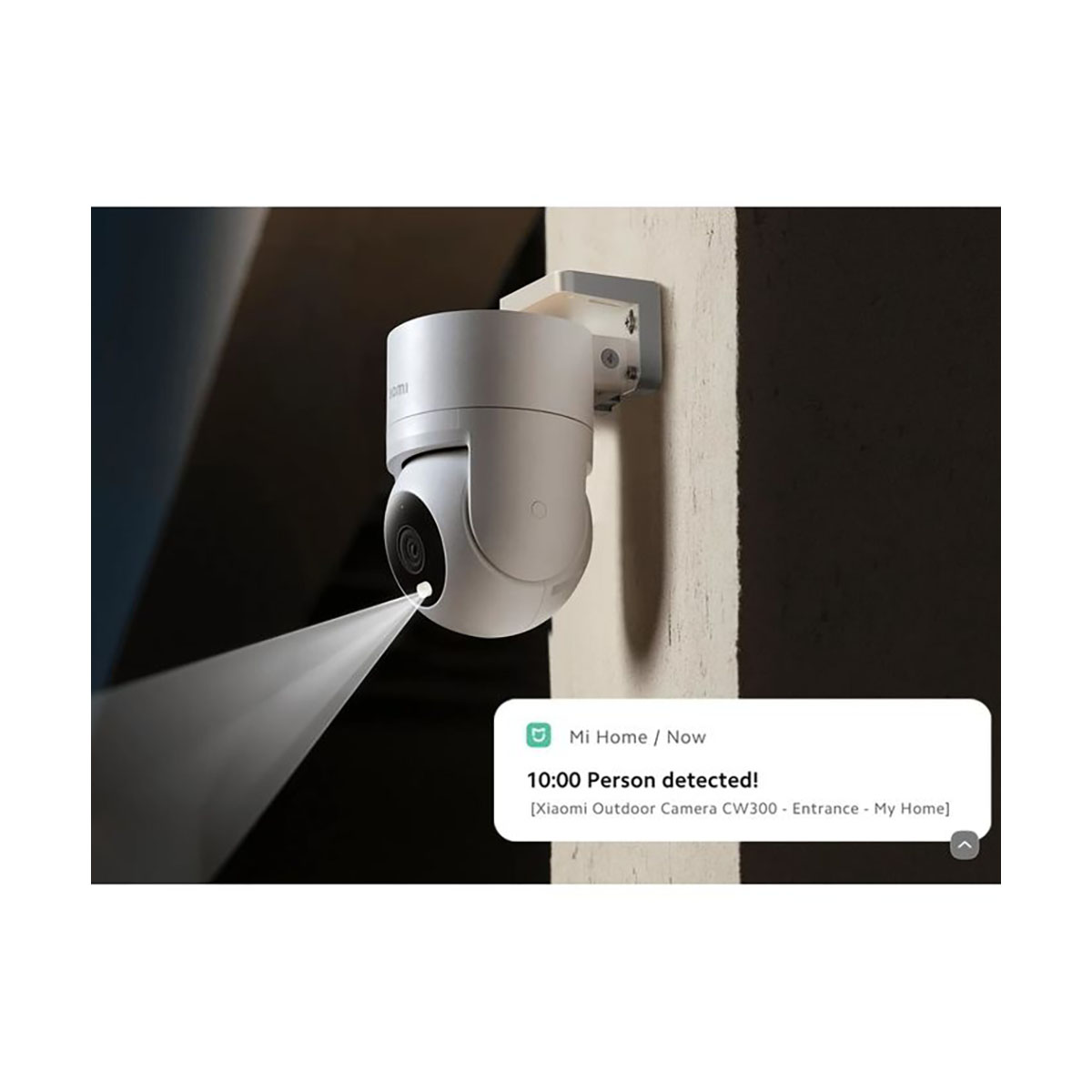 Biała kamera bezpieczeństwa na ścianie, emitująca wiązkę światła. Powiadomienie: 'Wykryto osobę!'