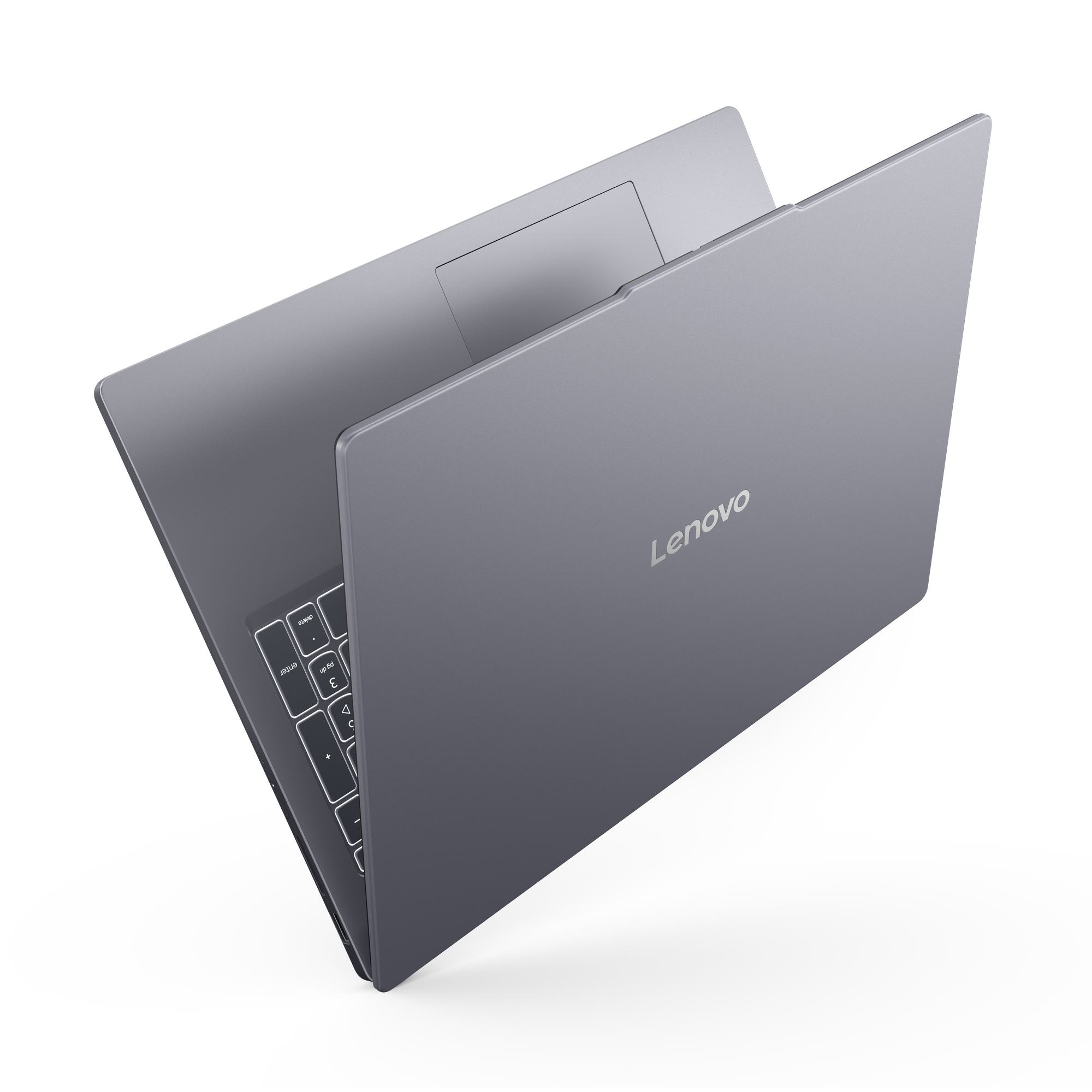 Szary laptop Lenovo jest częściowo zamknięty, pokazując tył i klawiaturę. Logo Lenovo jest widoczne.