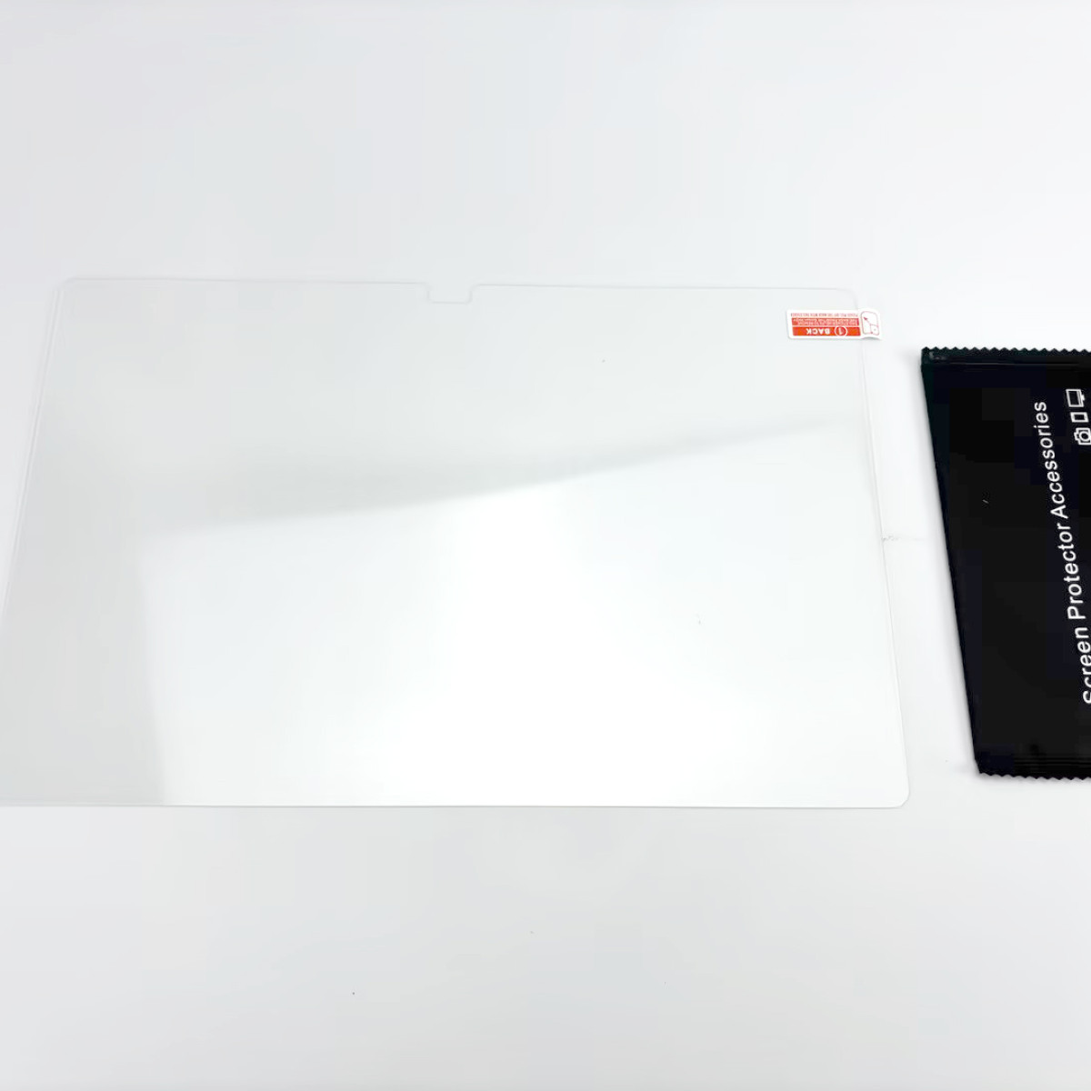 Een schermbeschermer en een zwart pakket, Screen Protector Accessories, liggen op een wit oppervlak.