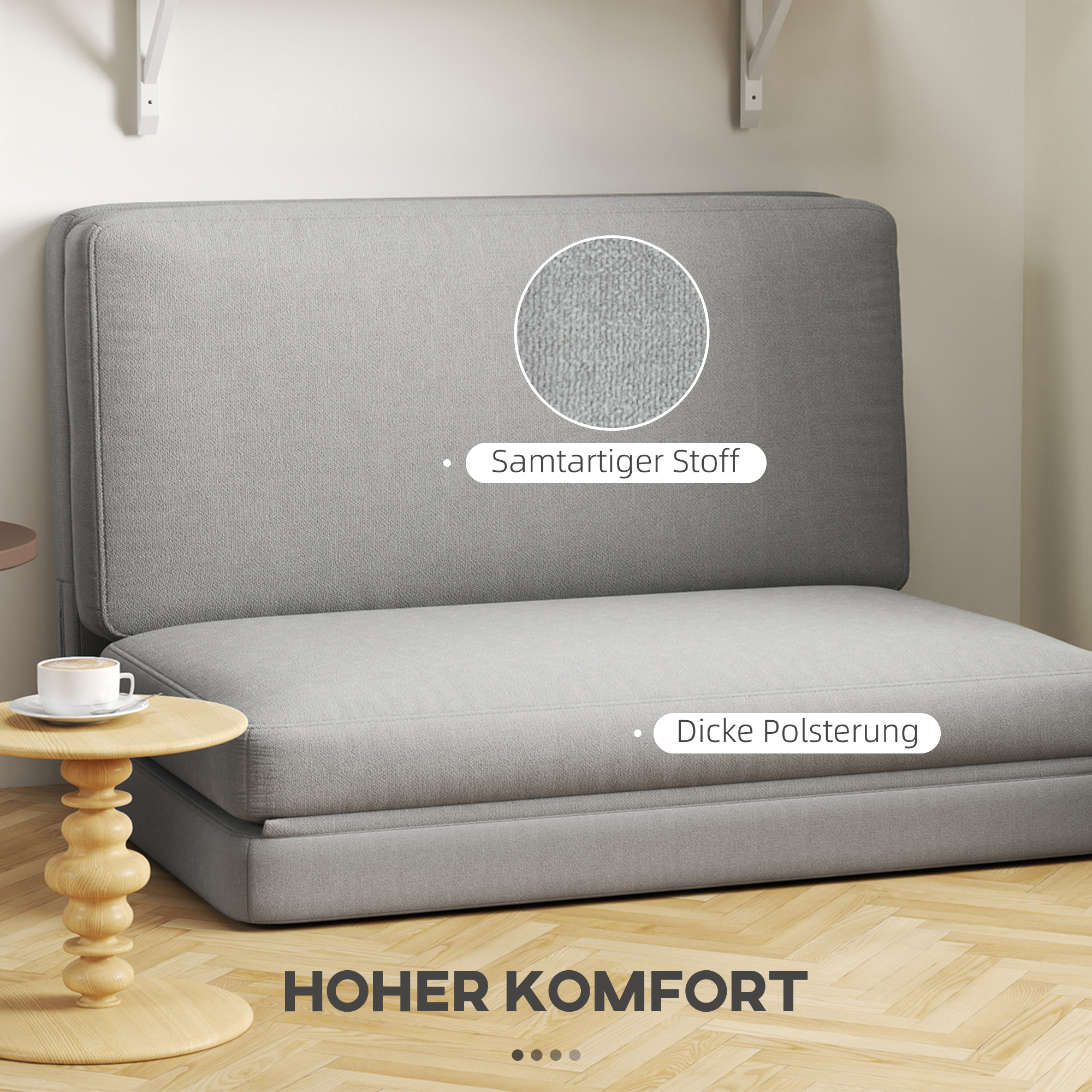 Graues Schlafsofa, zu einem Sitz zusammengeklappt. Text zeigt 'hoher Komfort'. Stoff-Nahaufnahme.