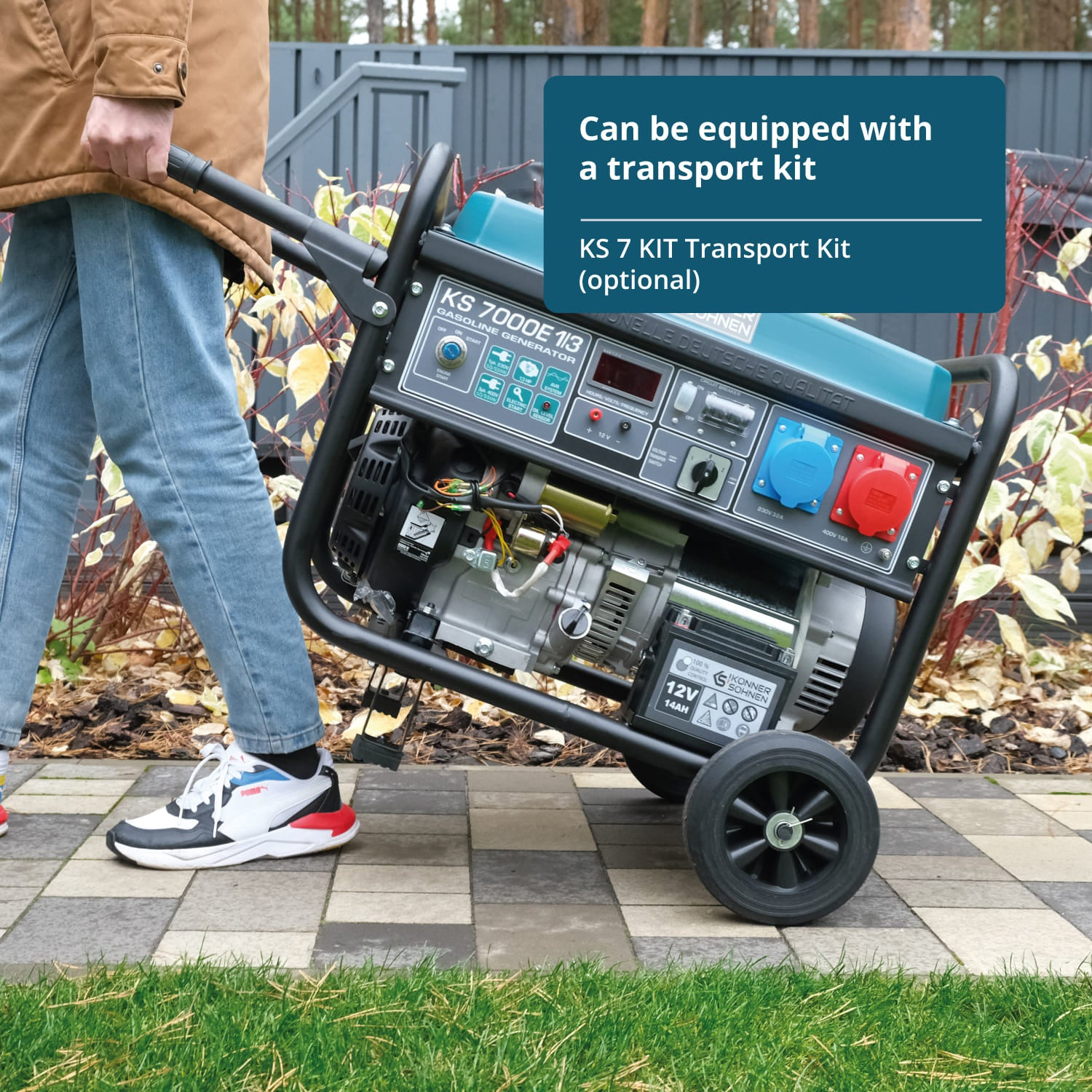 Osoba przewozi generator z zestawem transportowym. Generator jest niebiesko-czarny.