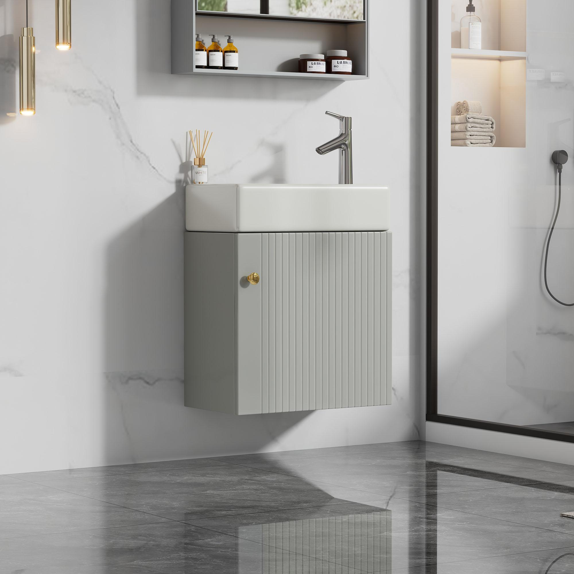 Ein moderner, grauer Badezimmer-Waschtischschrank mit einem weißen Waschbecken, einem Wasserhahn und einem Spiegel. Der Boden ist graue Fliesen.