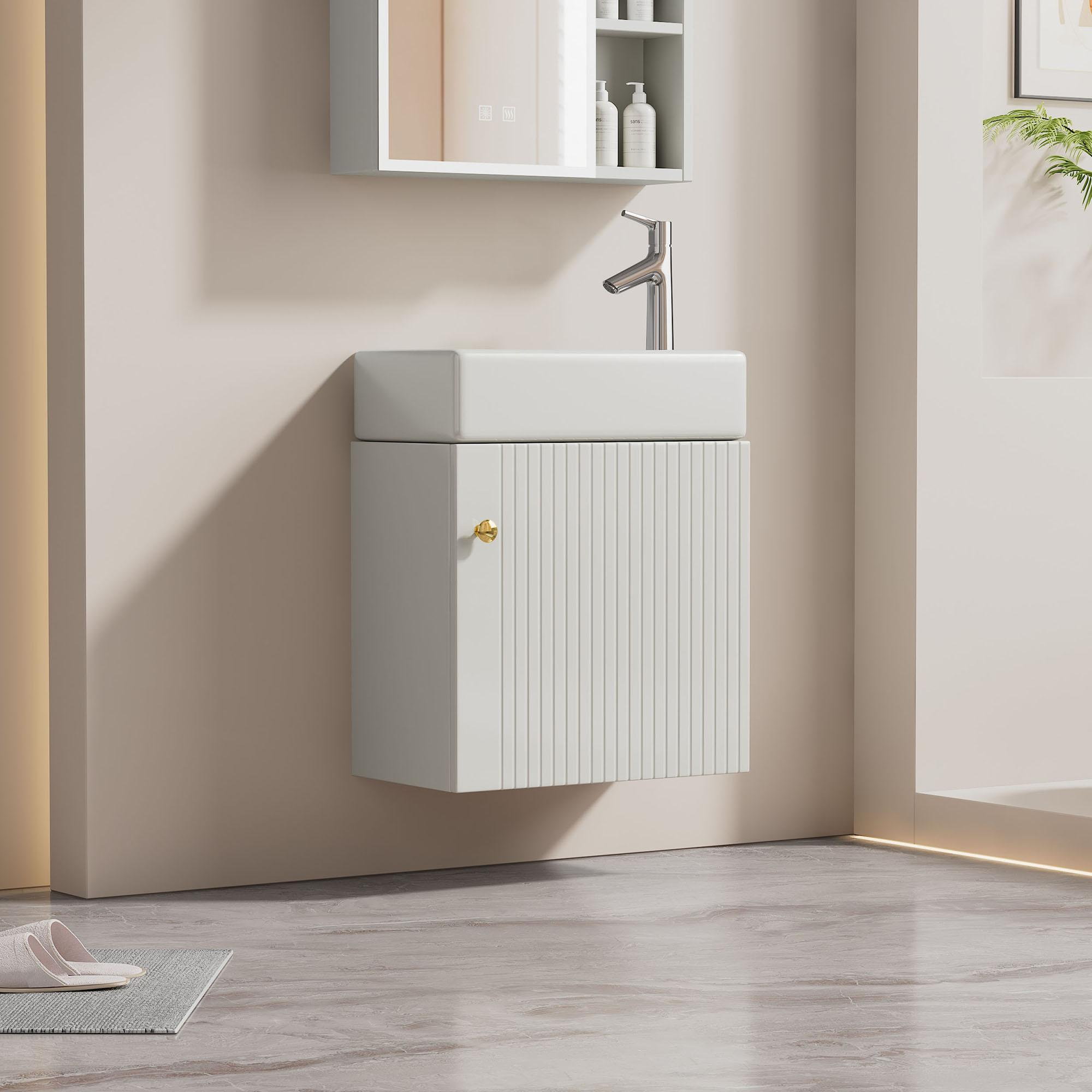 An der Wand montierter Waschtischunterschrank mit Spiegel, Waschbecken und goldenem Griff an der Tür.