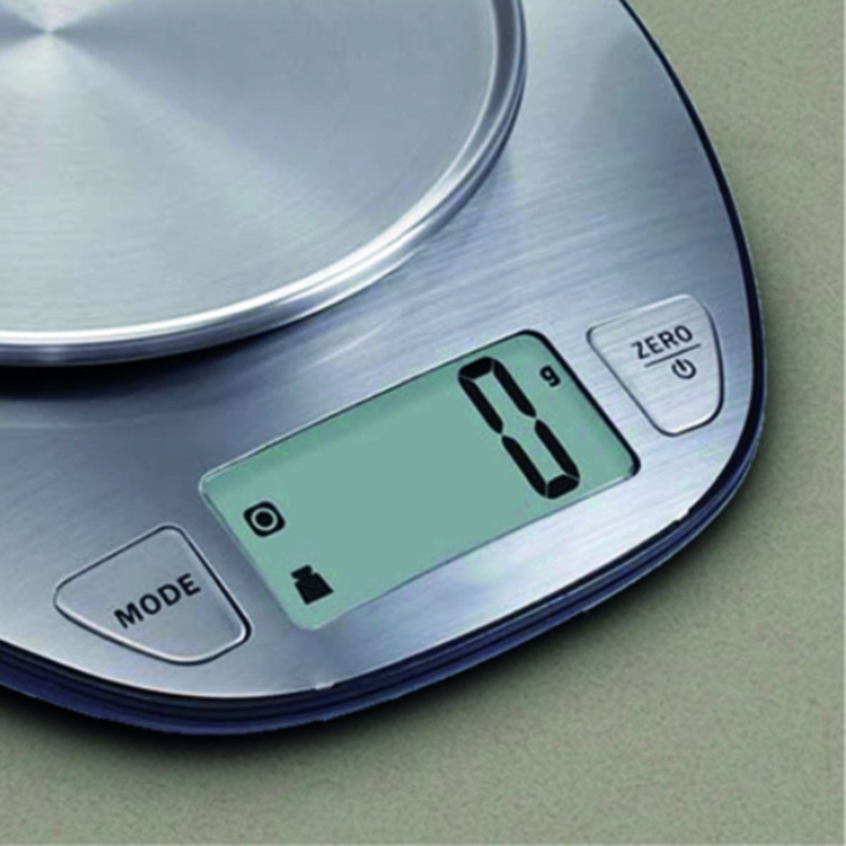 Balanza de cocina digital. Muestra '0 g' en la pantalla. Botones Modo y Cero visibles.