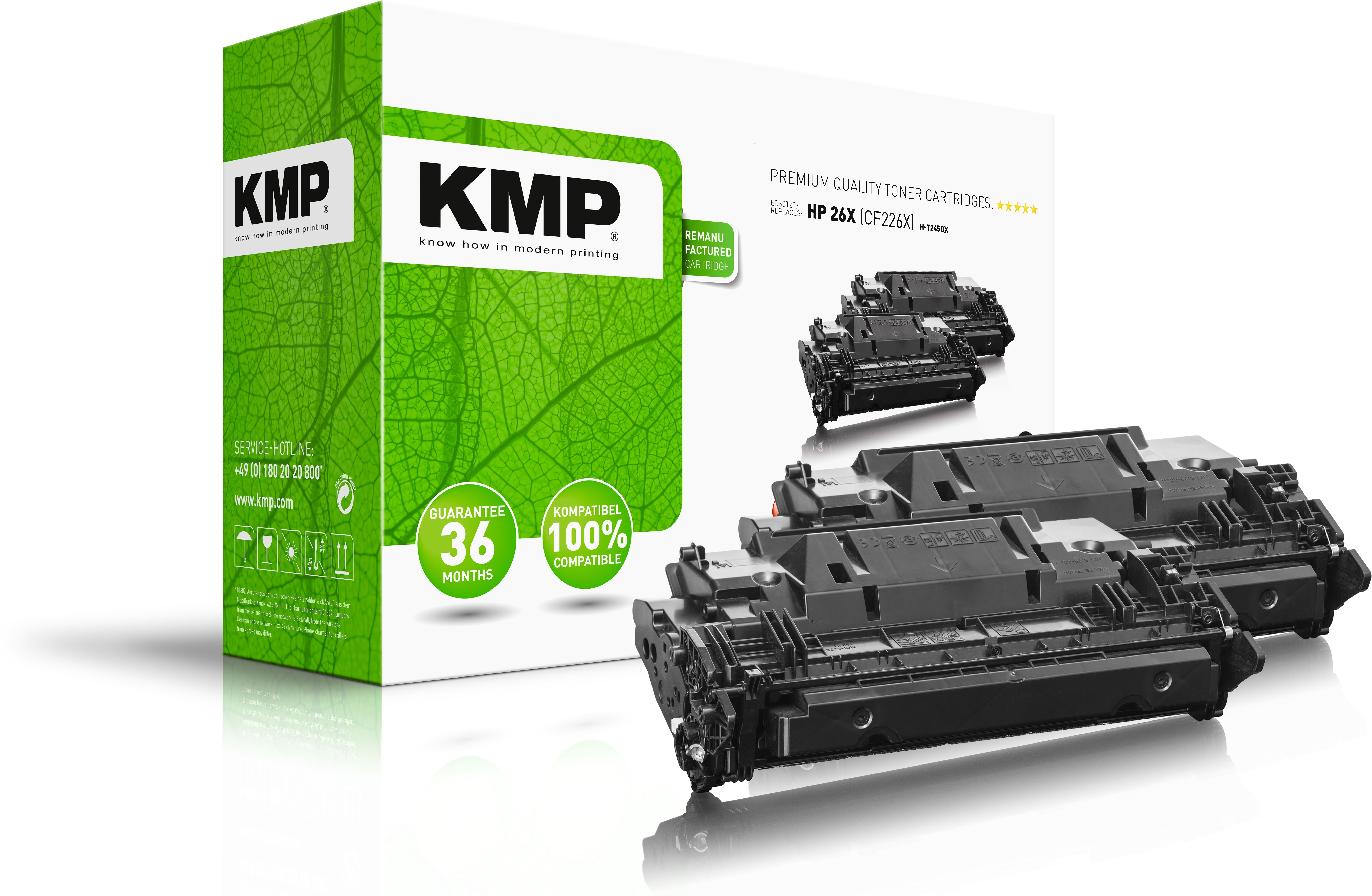 Cartucce toner KMP in una scatola con un design a foglie verdi. Sfondo bianco.