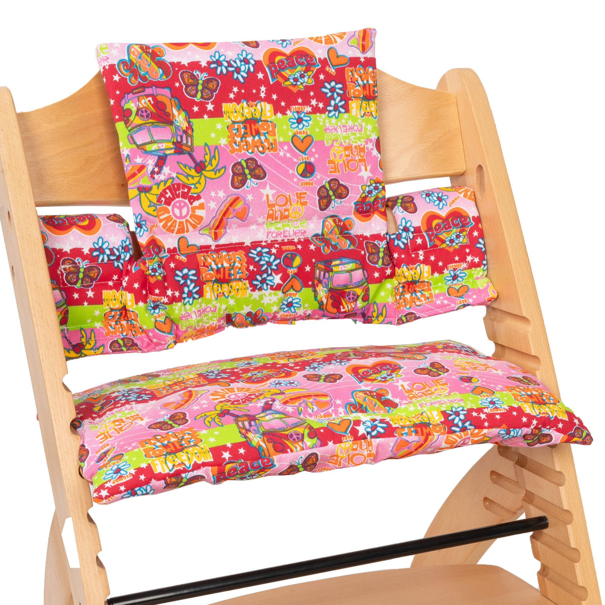 Silla alta con cojines estampados en rojo, rosa, verde y blanco. El patrón incluye corazones y símbolos de paz.
